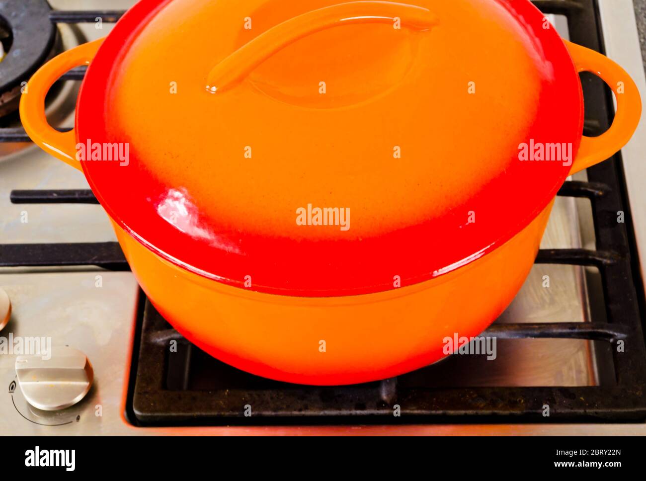 two bright orange pots from cast iron with enamel at an old vintage gas stove Stock Photo Alamy