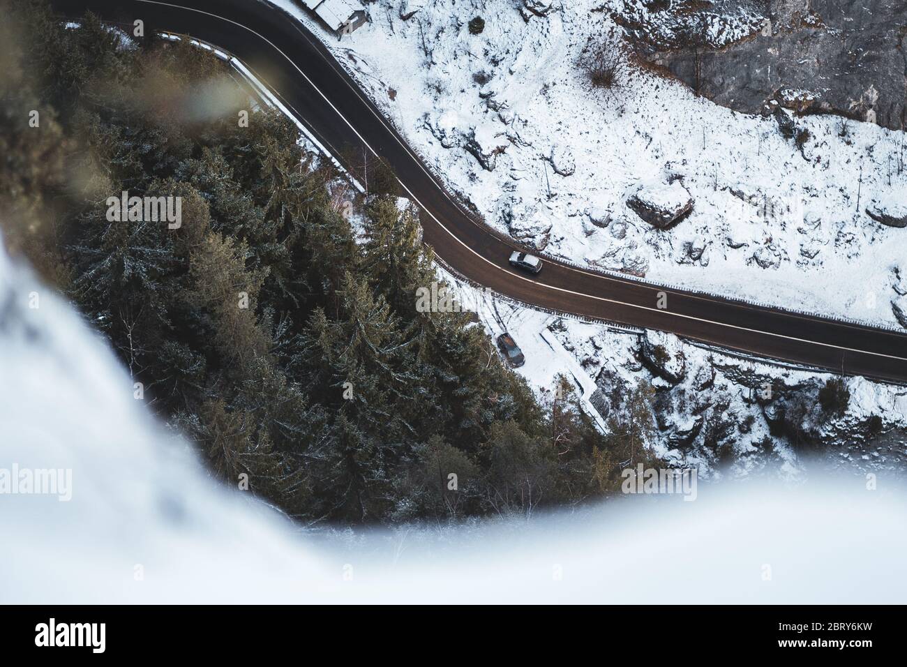 Car on road in winter trough forest and snowy landscape in Bicaz Chei, Romania Stock Photo