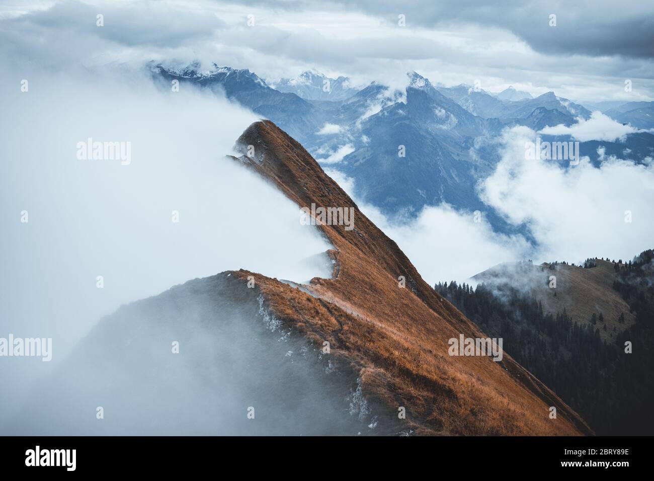Panorama over the Swiss alps overlooking the Bernese Oberland. Moody scenery with fog surrounding ridges from the Augstmatthorn,  Emmental Alps Stock Photo