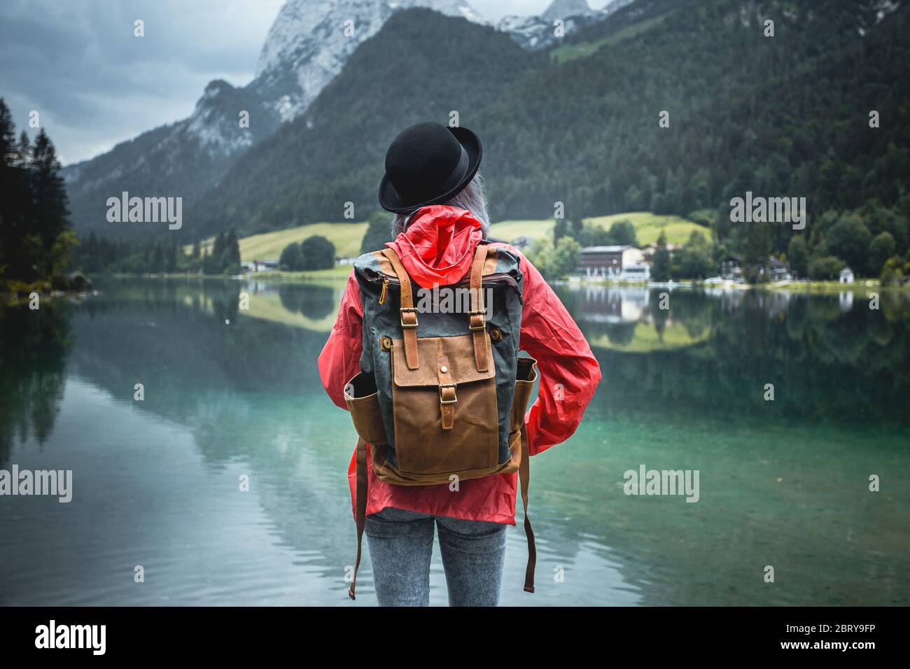 Female backpacker looking at mountain by the lake. Relax time on holiday concept travel,selective and soft focus,tone of hipster style Stock Photo