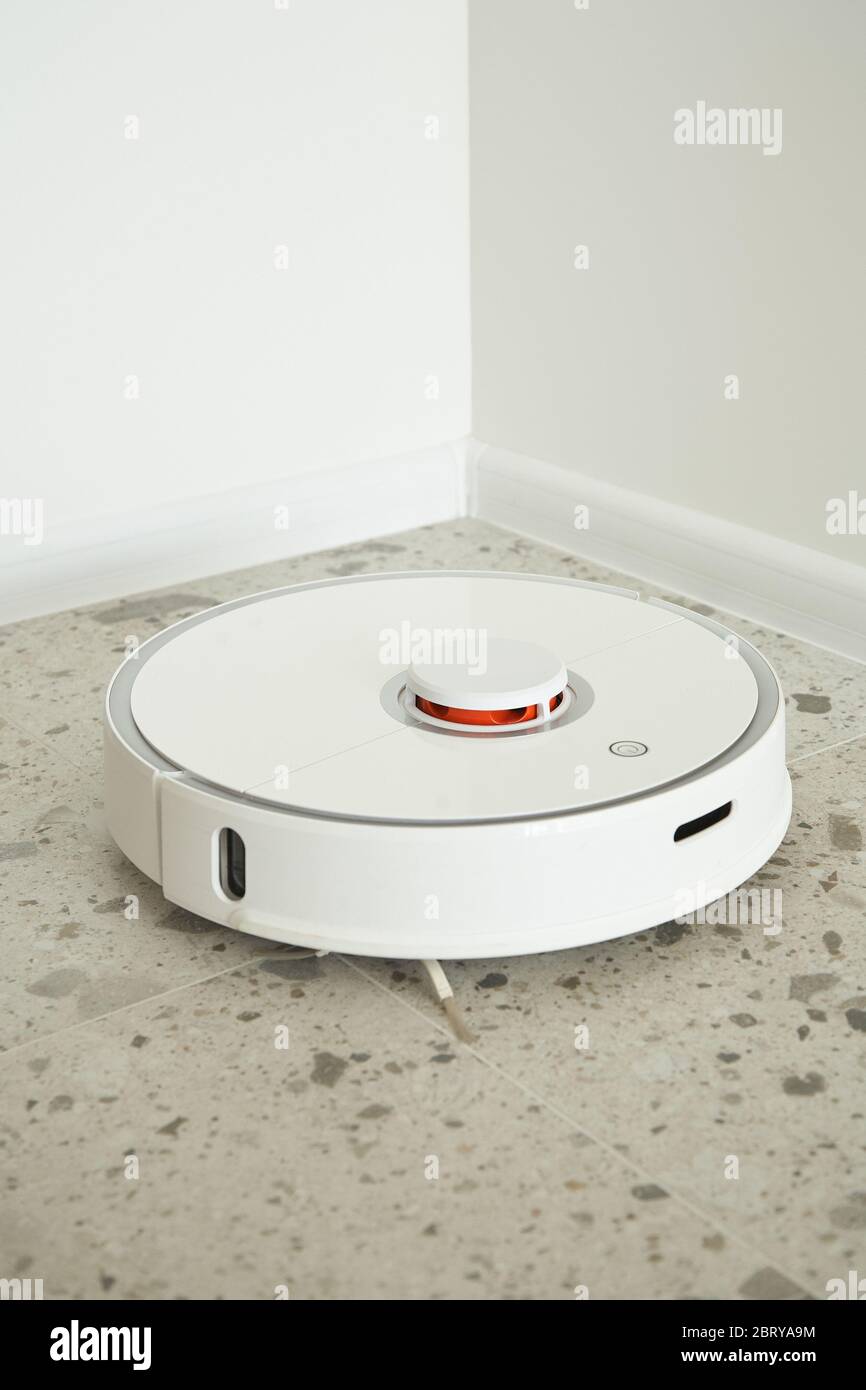 modern robotic vacuum cleaner washing floor tiles near white walls Stock Photo Alamy