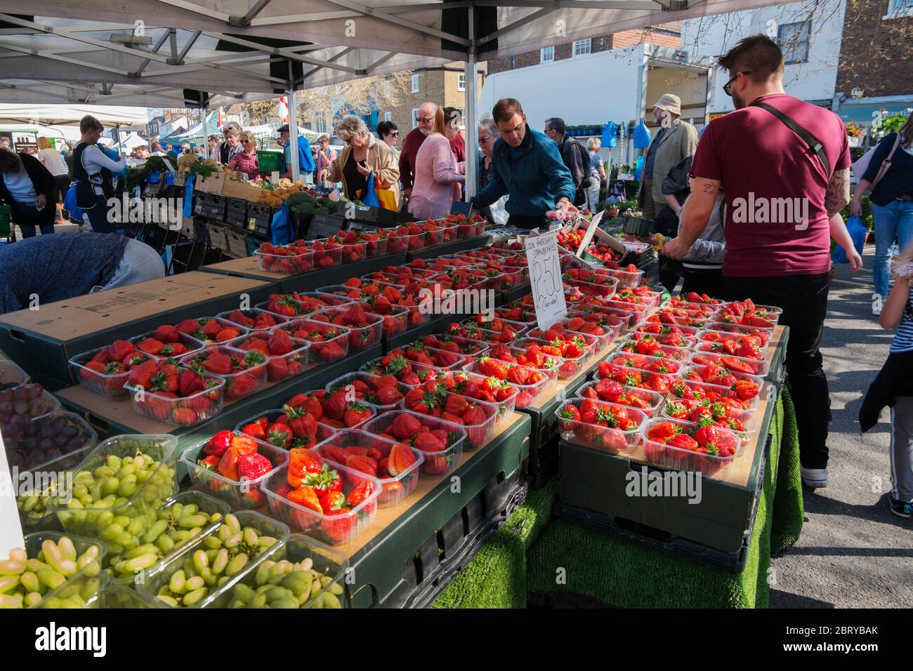 People buying of first of the season Faversham strawberries at