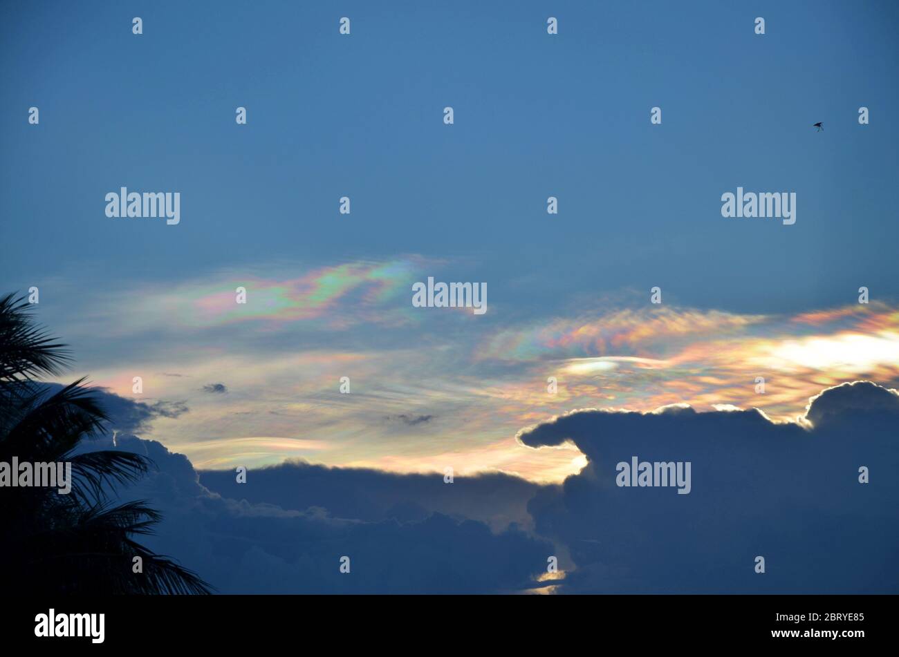 Rainbow-colored light effects around clouds in Monsoon season in South-East Asia Stock Photo