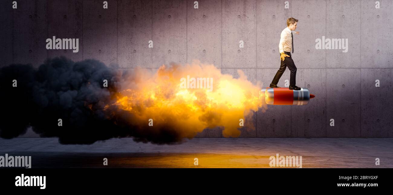 businessman above rockets causing a big flame and smoke. concrete background. concept of innovation, creativity, initiative, success. Stock Photo