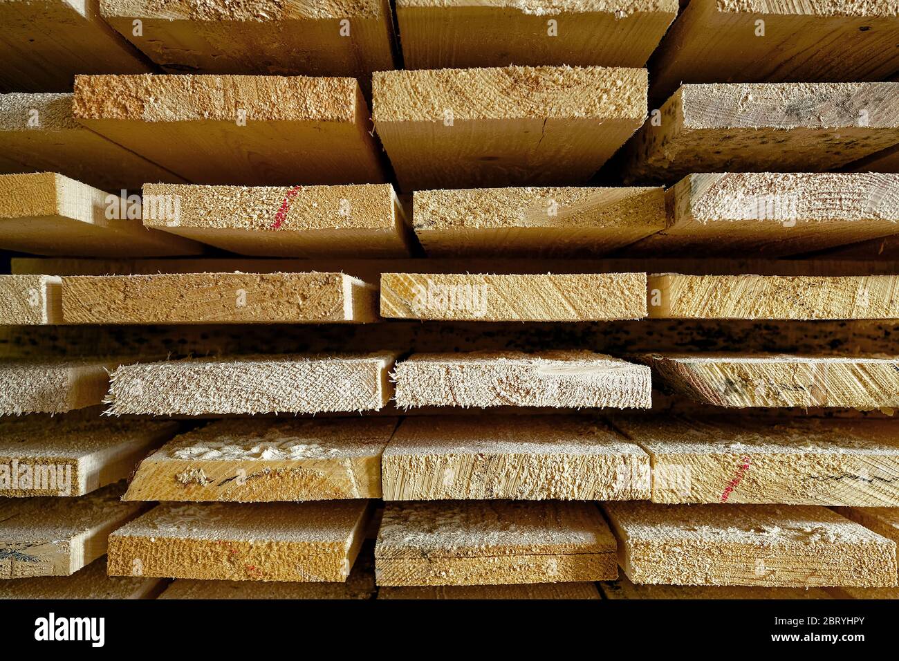 Construction lumber. Dry boards are stacked. A closeup of wood in the