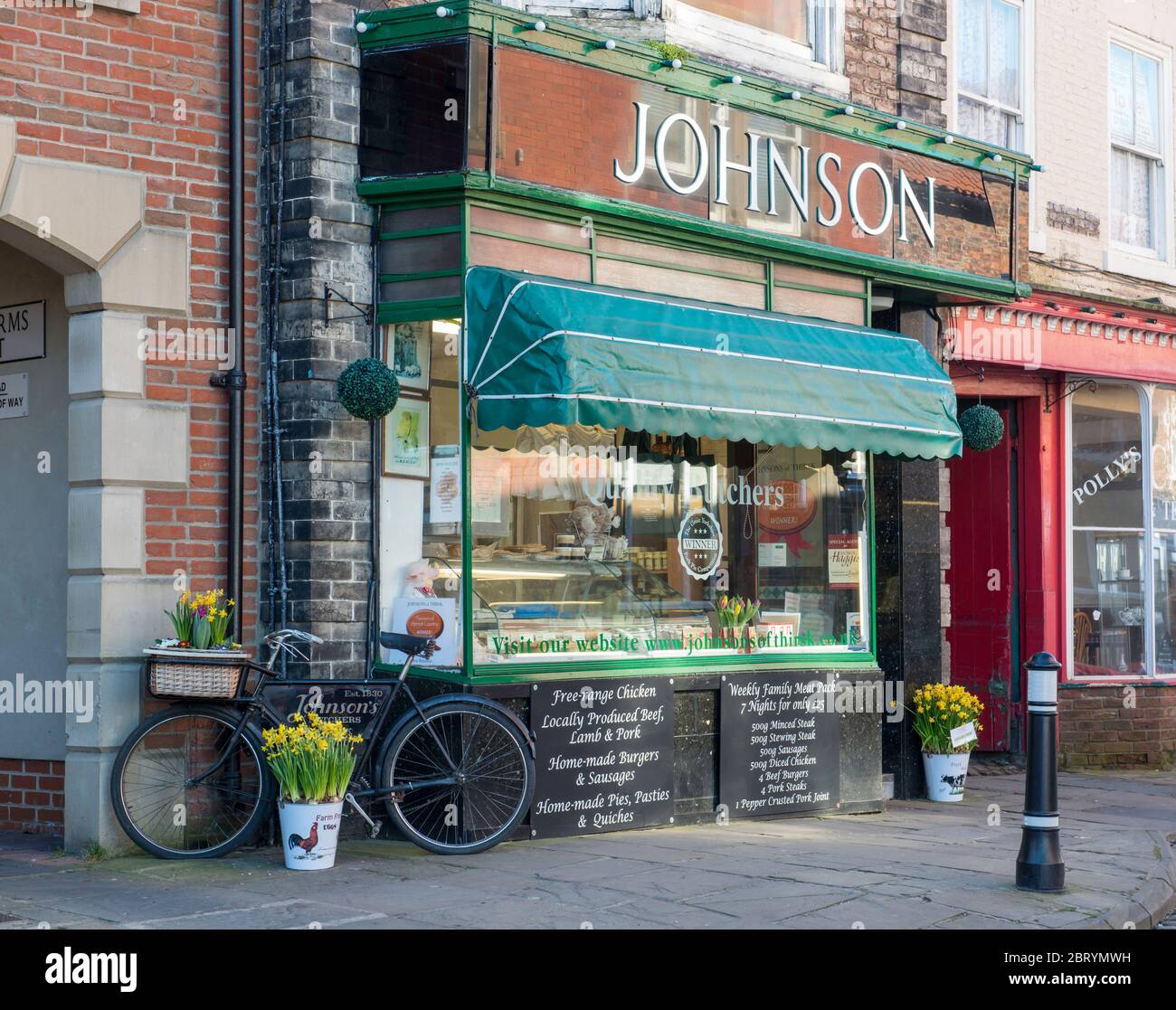 Exterior view of the display frontage of Johnson's traditional butcher shop in Thirsk, North Yorkshire with a butcher's bike Stock Photo
