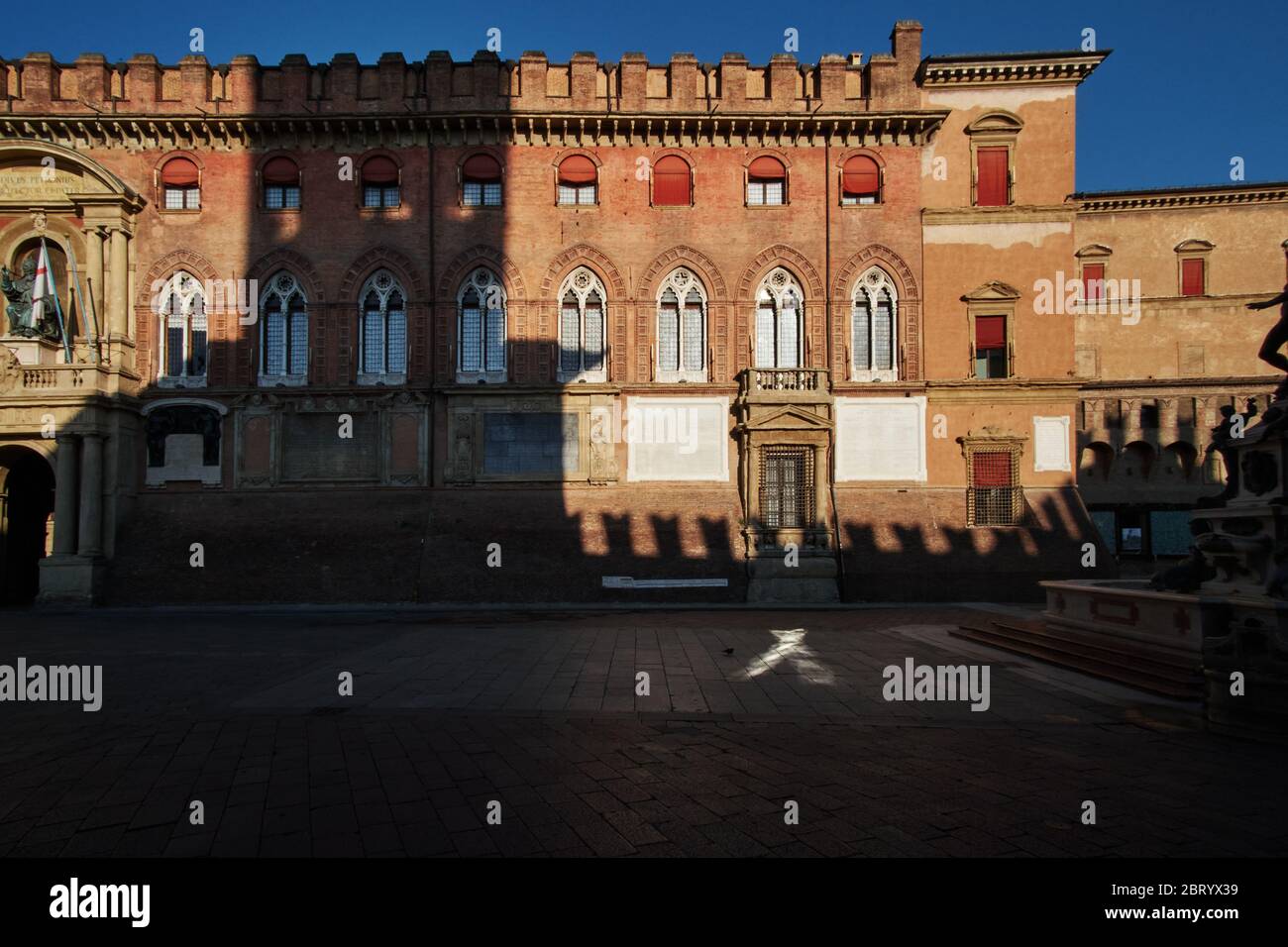 Bologna, Italy - May 21 2020:Palazzo d'Accursio, where the city's political activities reside, with the statue of Neptune by the artist Giambologna Stock Photo