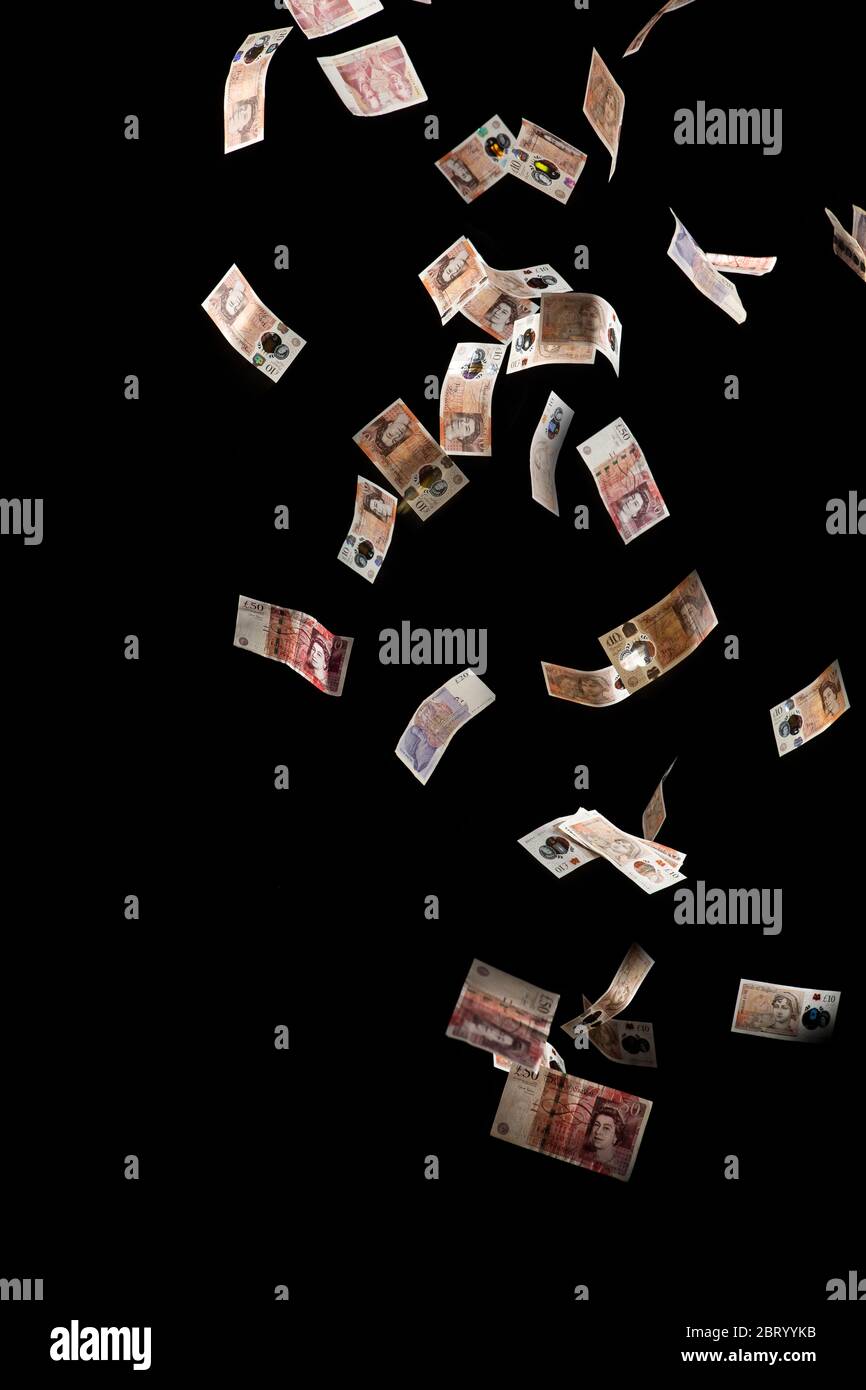British Money Falling Through The Air Against A Black Background The Pound Falling Stock Photo Alamy
