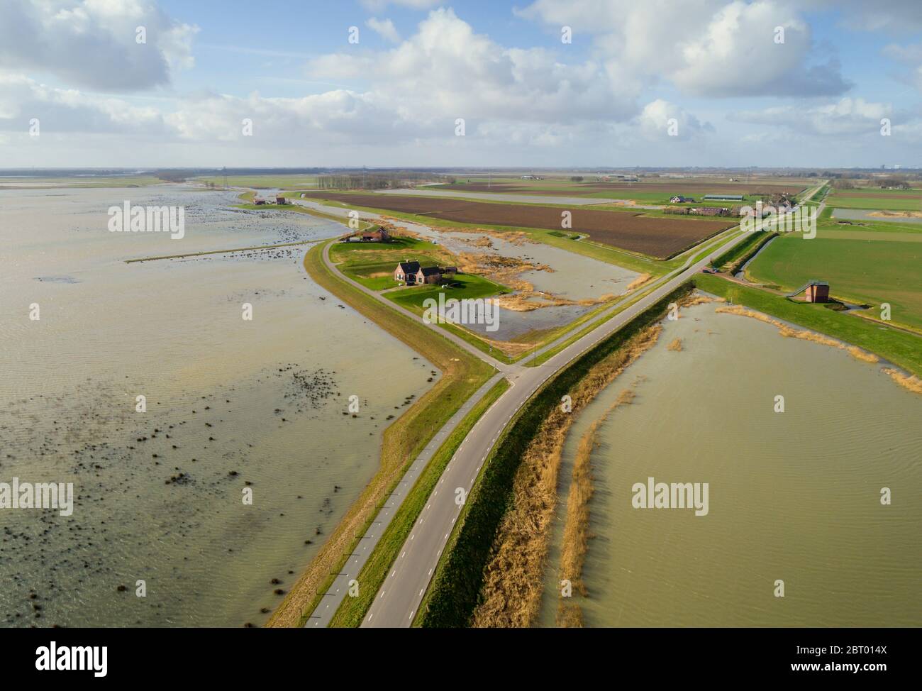 Aerial view of Wadden Sea nature reserve and a road along a dyke in Friesland, The Netherlands. Stock Photo