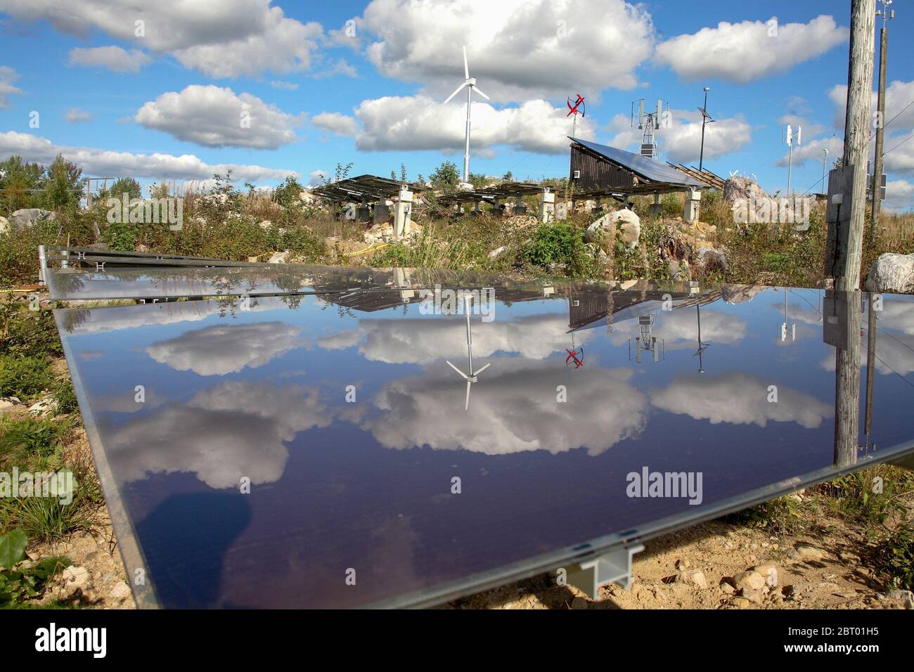 Clouds are reflected in a SOLAR PANEL in an energy park Stock Photo