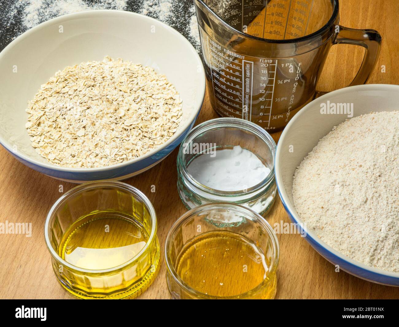 Ingredients for oat and spelt soda bread laid out on a kitchen table Stock Photo