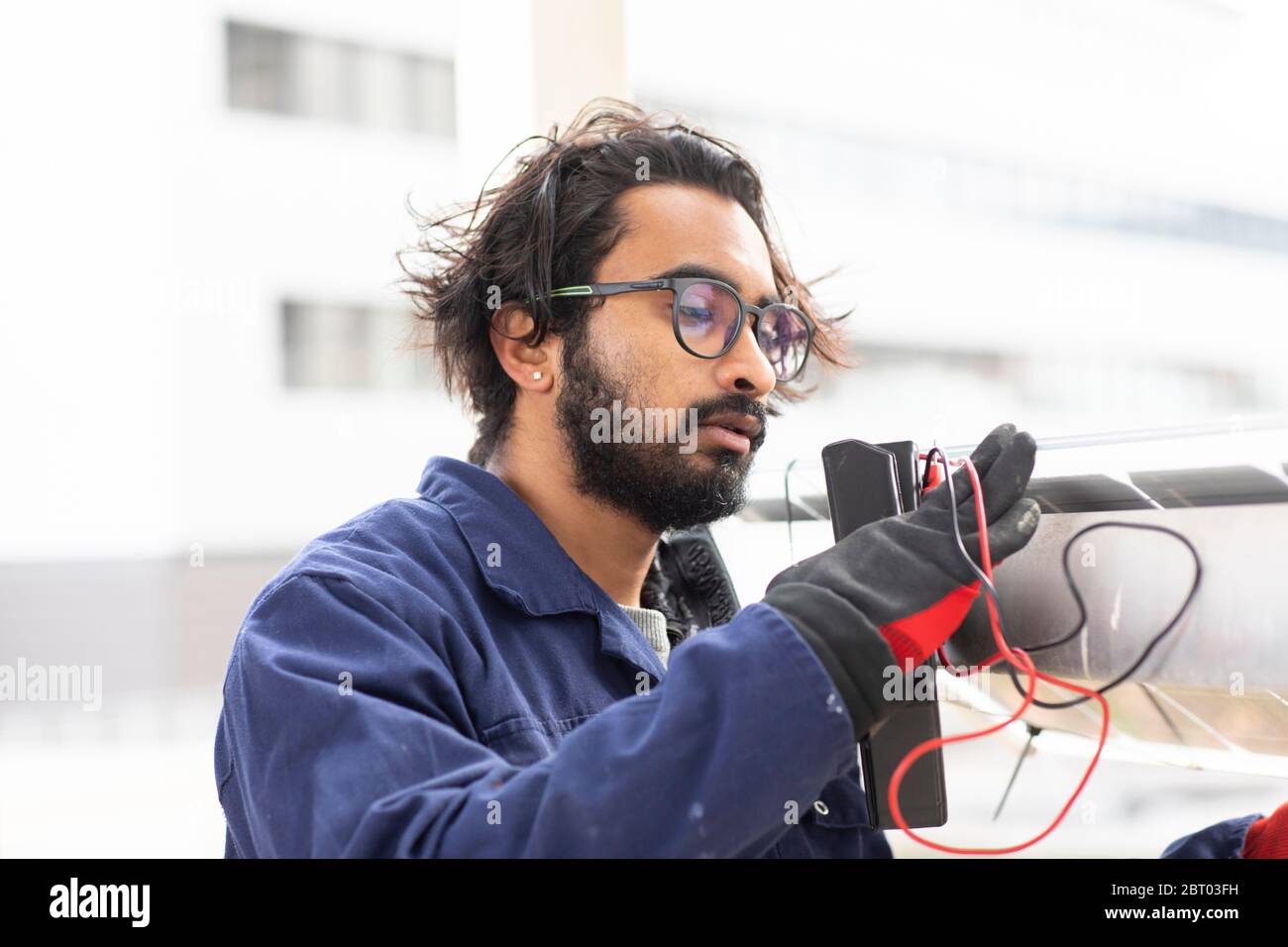 Bearded man wearing eyeglasses working on construction site. Stock Photo