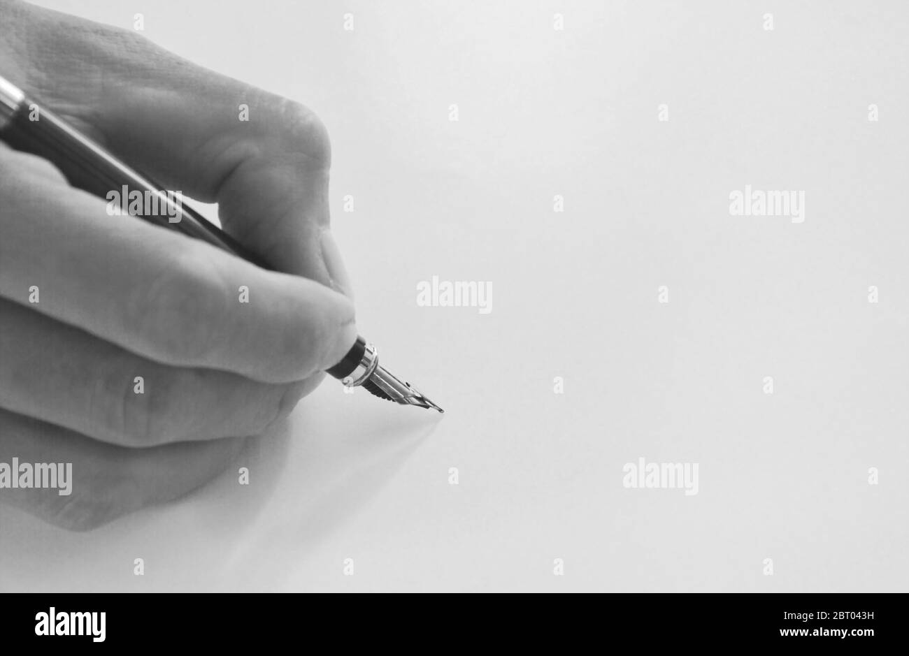 hand holding fountain pen write on white paper Stock Photo Alamy