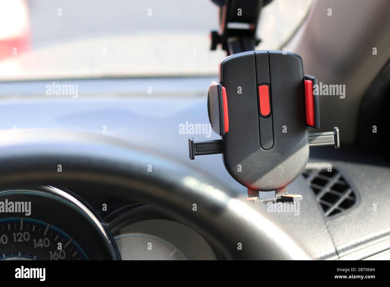 Mobile phone holder on the car for safety while driving a vehicle. Stock Photo