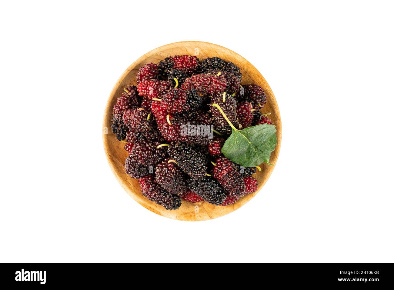 Top view pile of ripe mulberries in a wooden plate on white background with clipping path Stock Photo