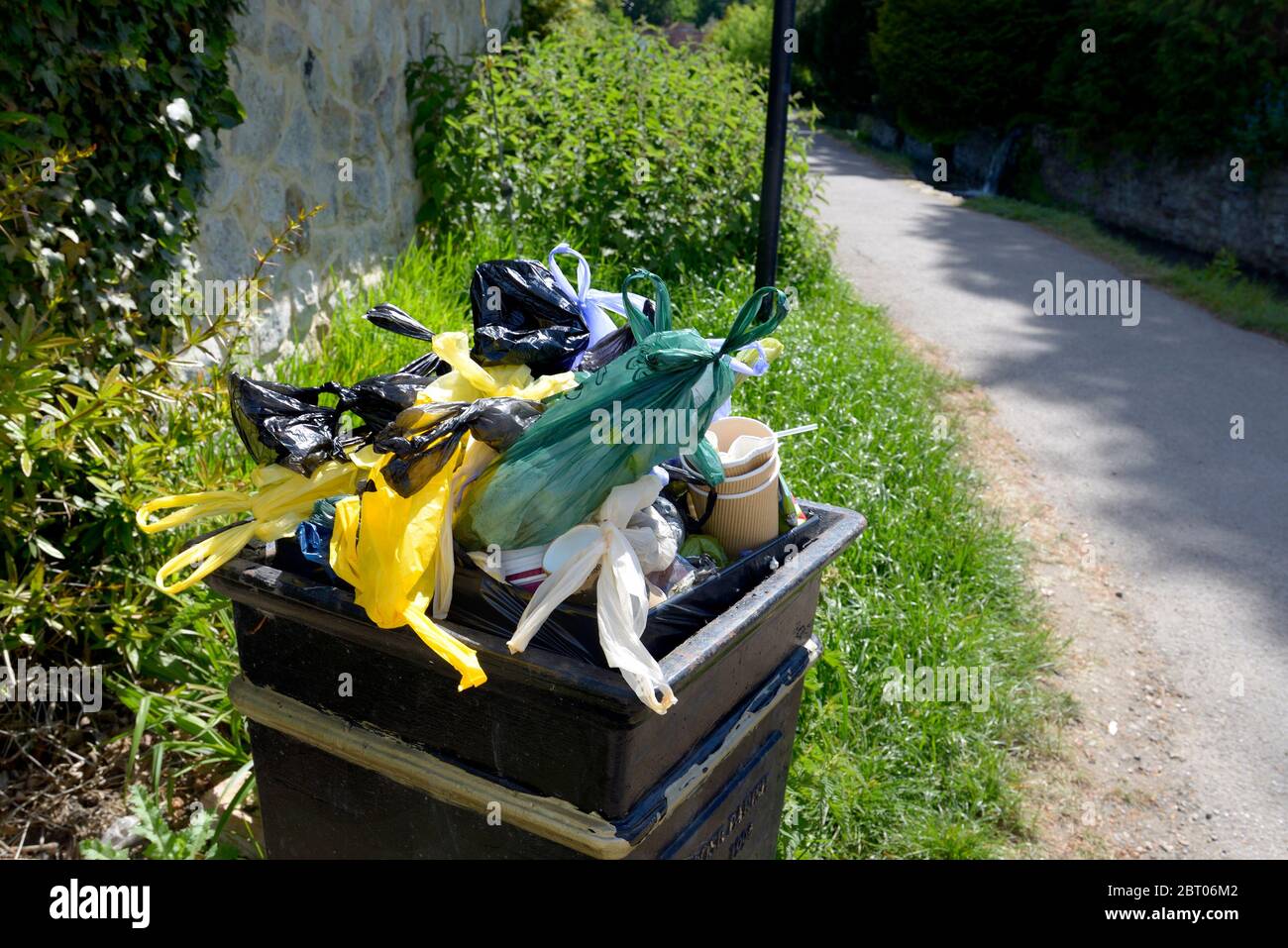 Loose Village, Kent, UK. Litter bin full of plastic bags Stock Photo