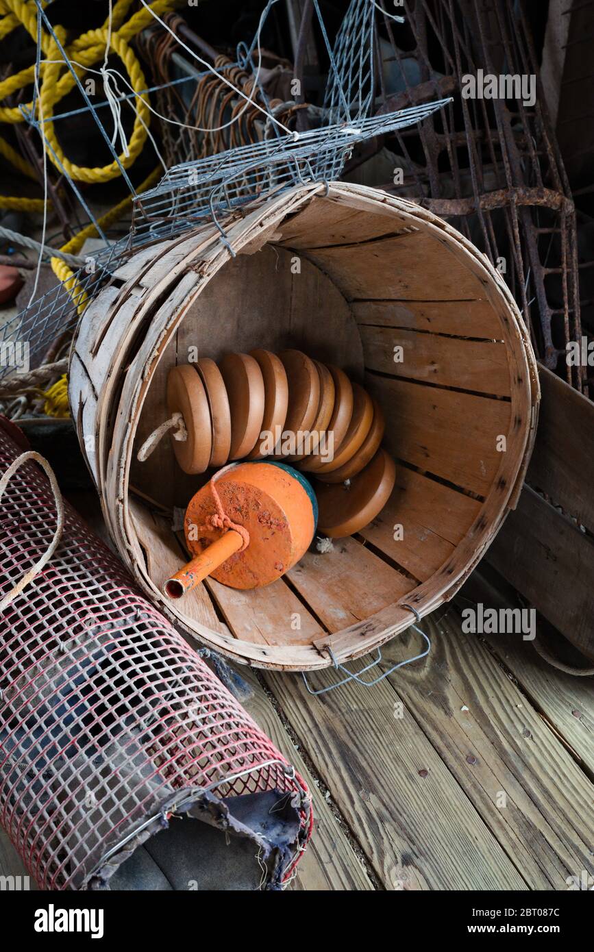 Commercial fishing floats stored in a wooden bushel basket Stock Photo