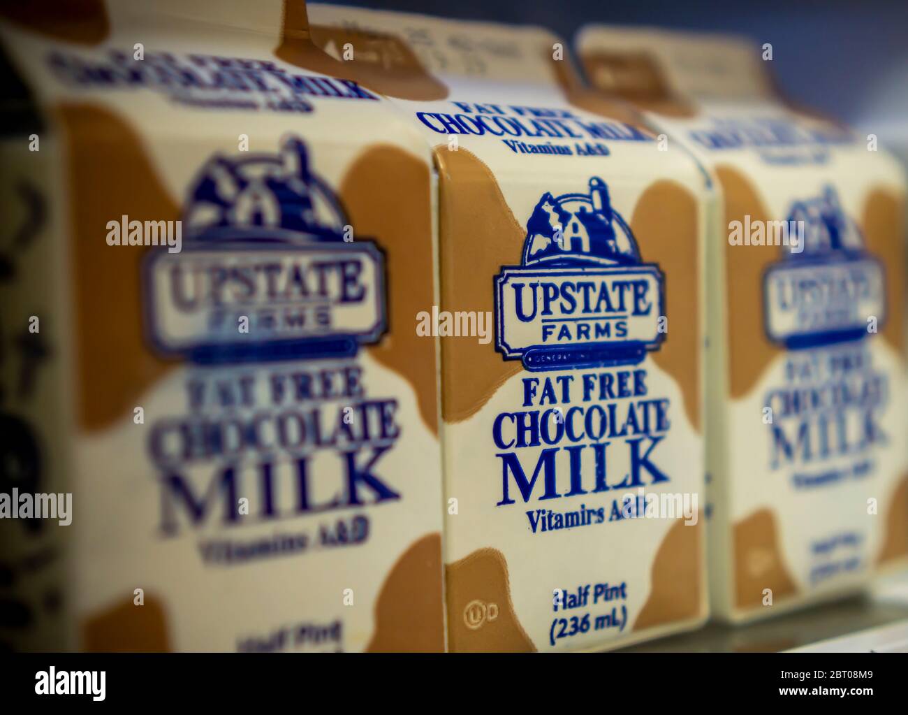Containers of Upstate Farms brand fat free chocolate milk in a refrigerator in New York on Thursday, May 14, 2020. Upstate Farms is a member of the Upstate Niagara Cooperative. New York Sate is partnering with Upstate Niagara Cooperative and other New York producers of dairy products to process excess milk and distribute the products to local food banks, otherwise milk would be discarded.  (© Richard B. Levine) Stock Photo
