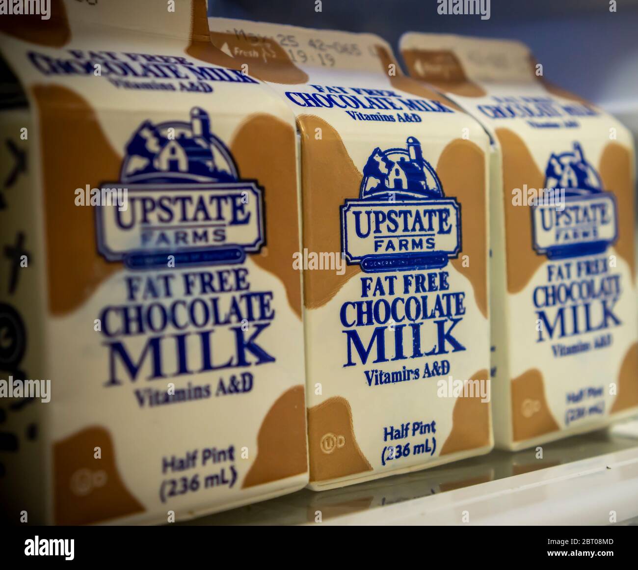 Containers of Upstate Farms brand fat free chocolate milk in a refrigerator in New York on Thursday, May 14, 2020. Upstate Farms is a member of the Upstate Niagara Cooperative. New York Sate is partnering with Upstate Niagara Cooperative and other New York producers of dairy products to process excess milk and distribute the products to local food banks, otherwise milk would be discarded.  (© Richard B. Levine) Stock Photo