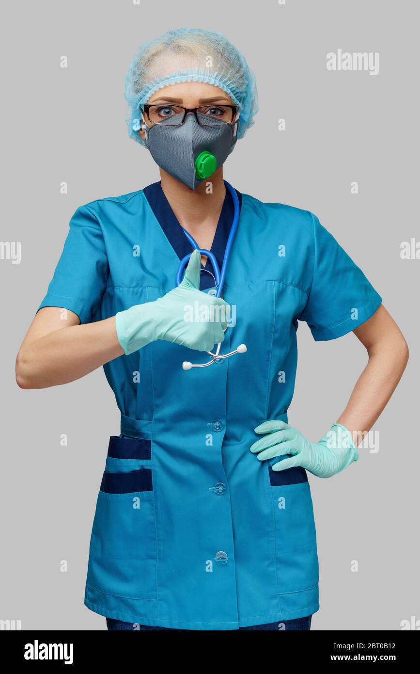female doctor with stethoscope wearing protective mask and latex gloves ...