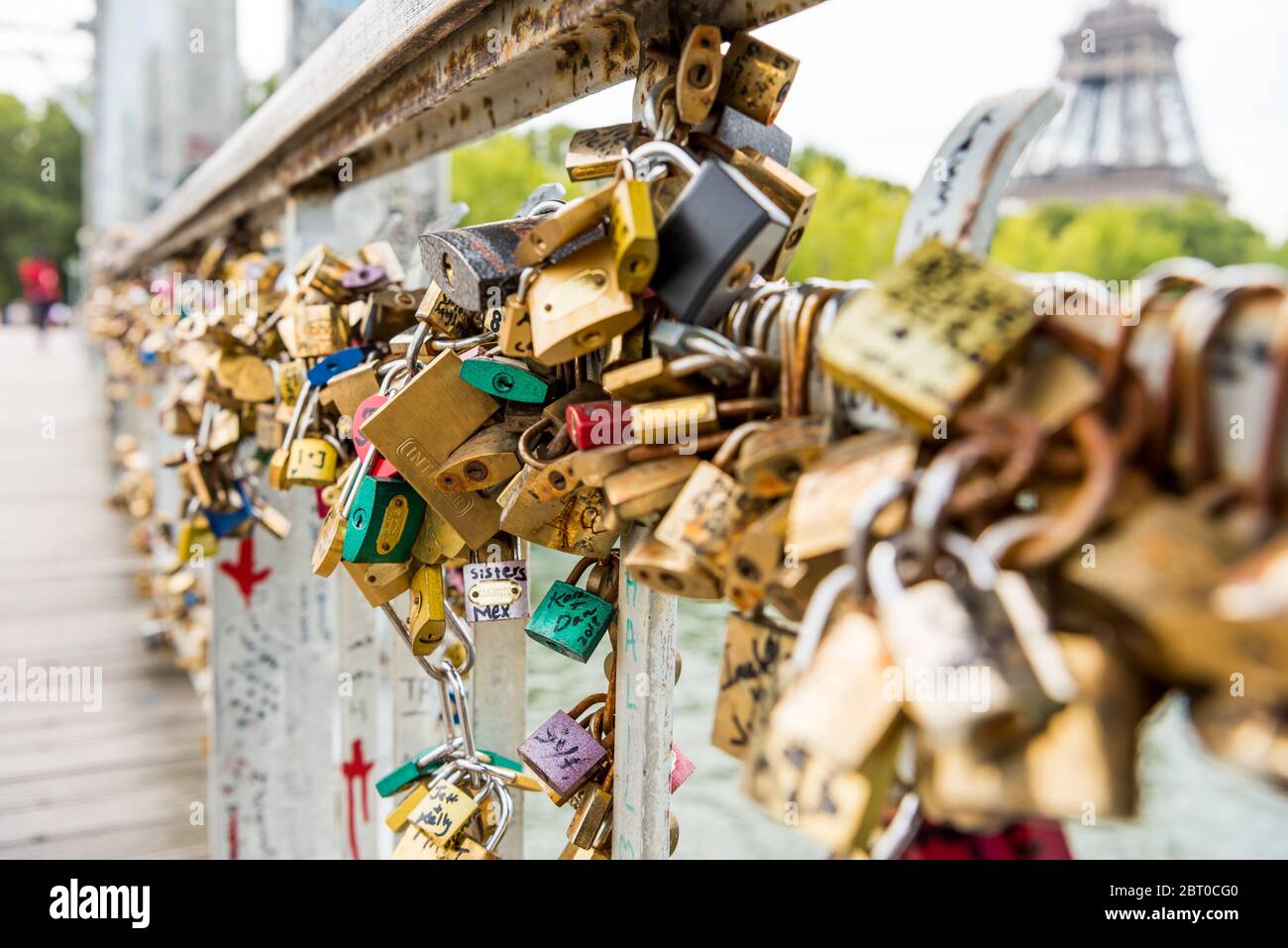 Padlocks on the wall of riverbank of Seine River with background of