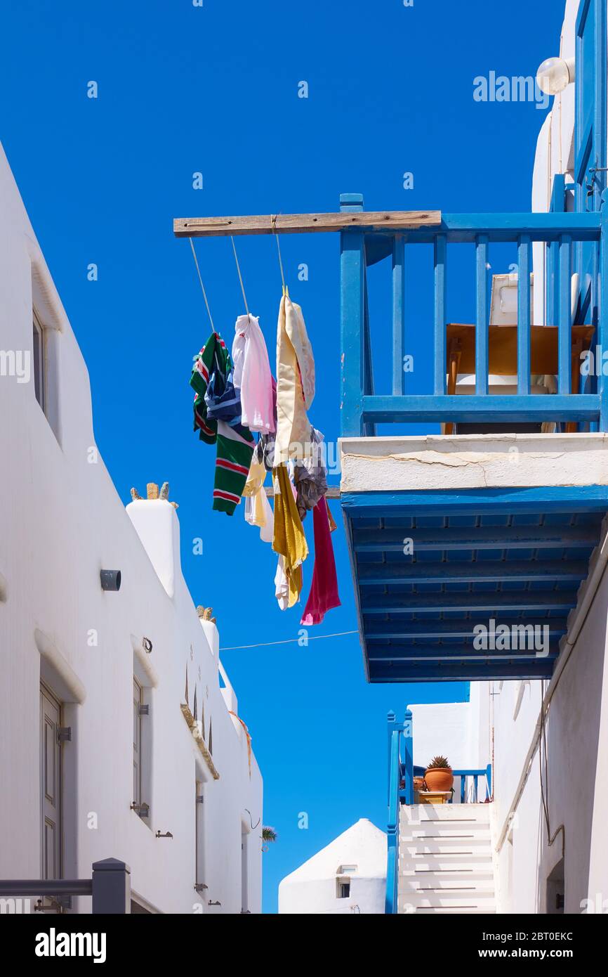 Balcony with airing clothes in Mykonos town, Greece Stock Photo