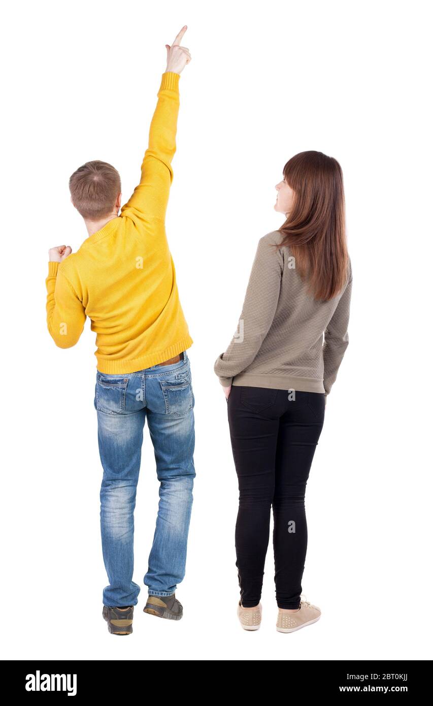 Back view of couple in sweater pointing. Rear view people collection ...