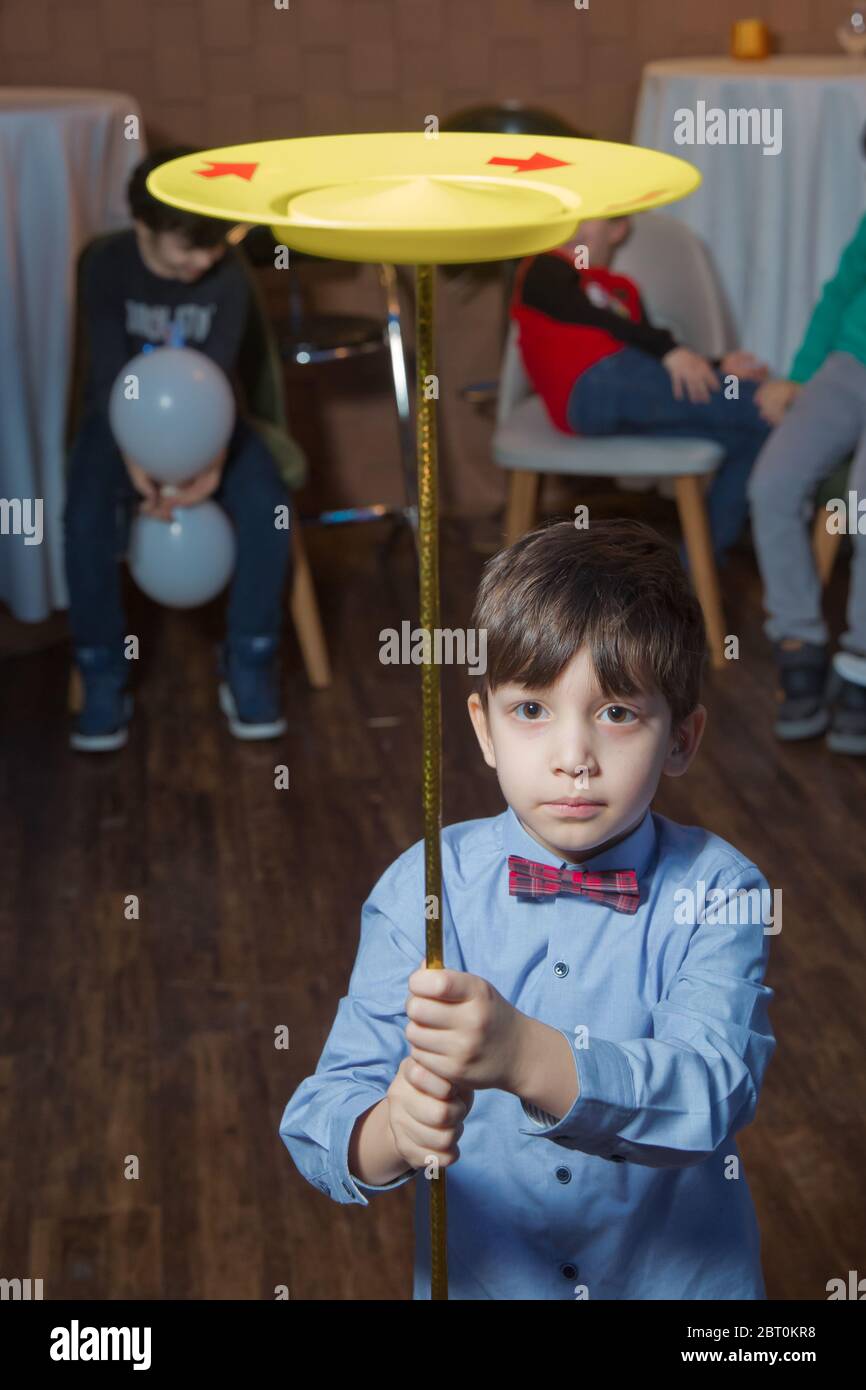 Child spinning white, blue, plates . Fun with Spinning Plates