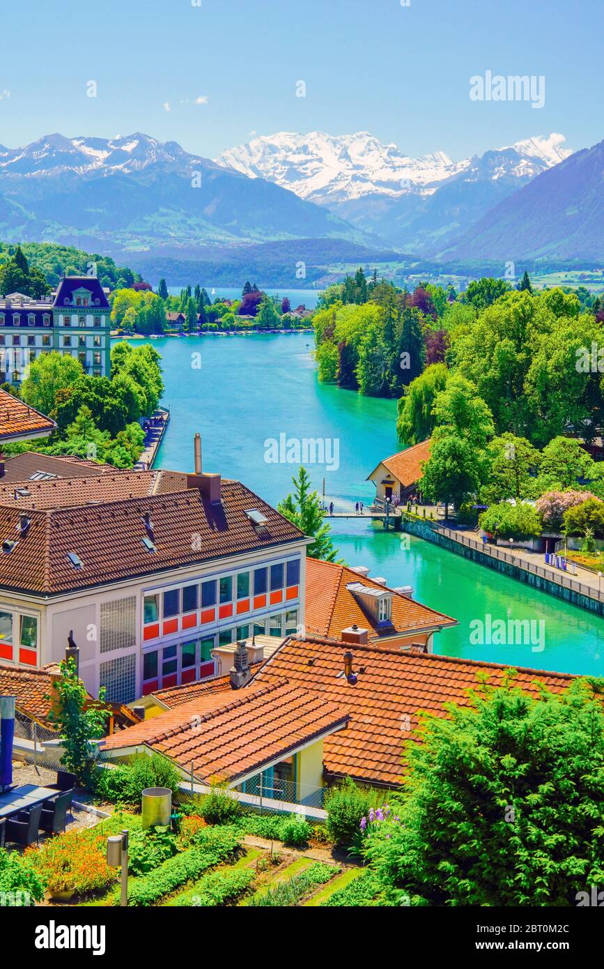 Elevated view of Old town Thun, Aarau river, Thun lake and snow covered Alps. Bern canton, Switzerland. Stock Photo