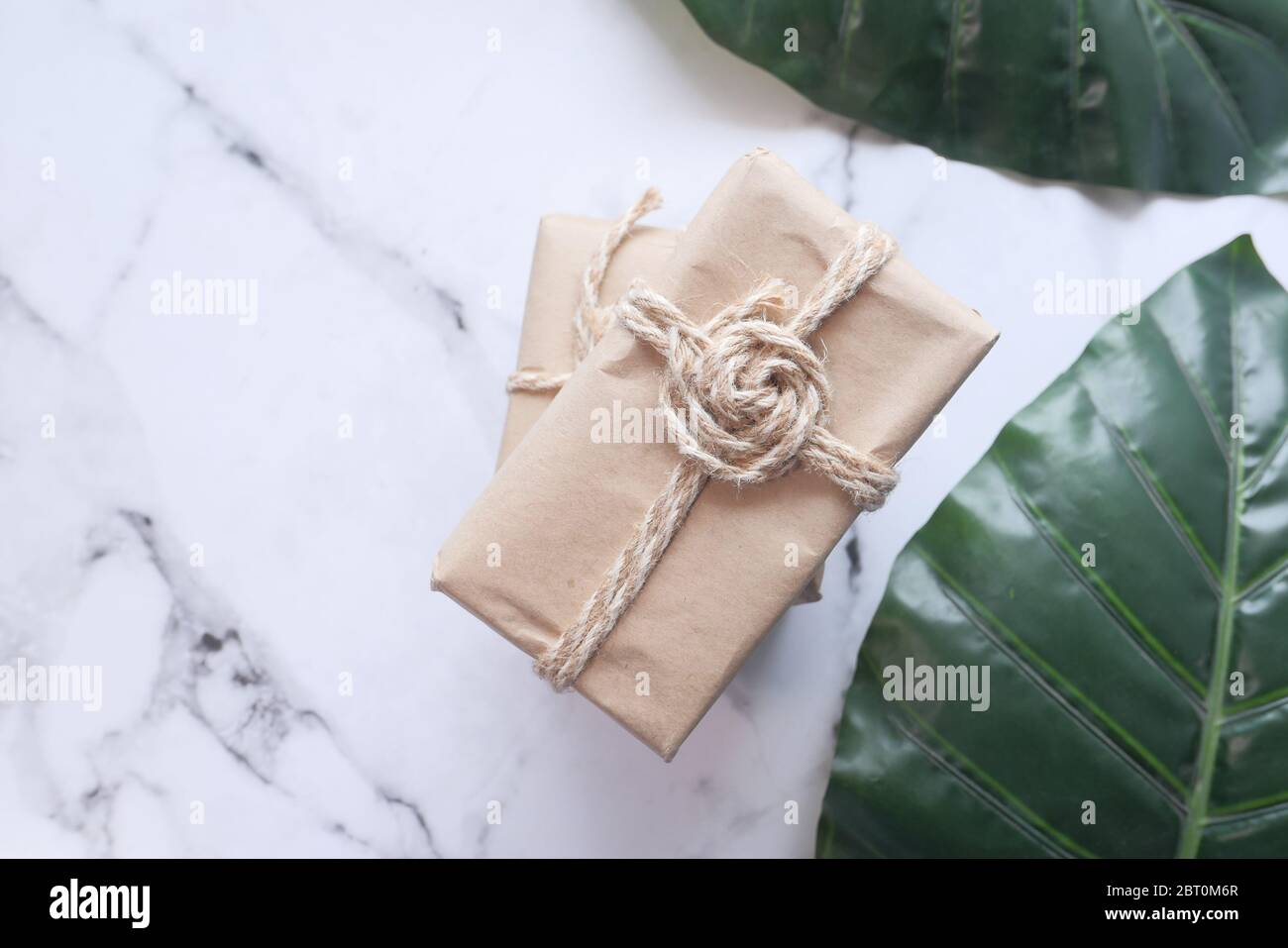 Handmade crafted paper gift boxes on wooden background  Stock Photo