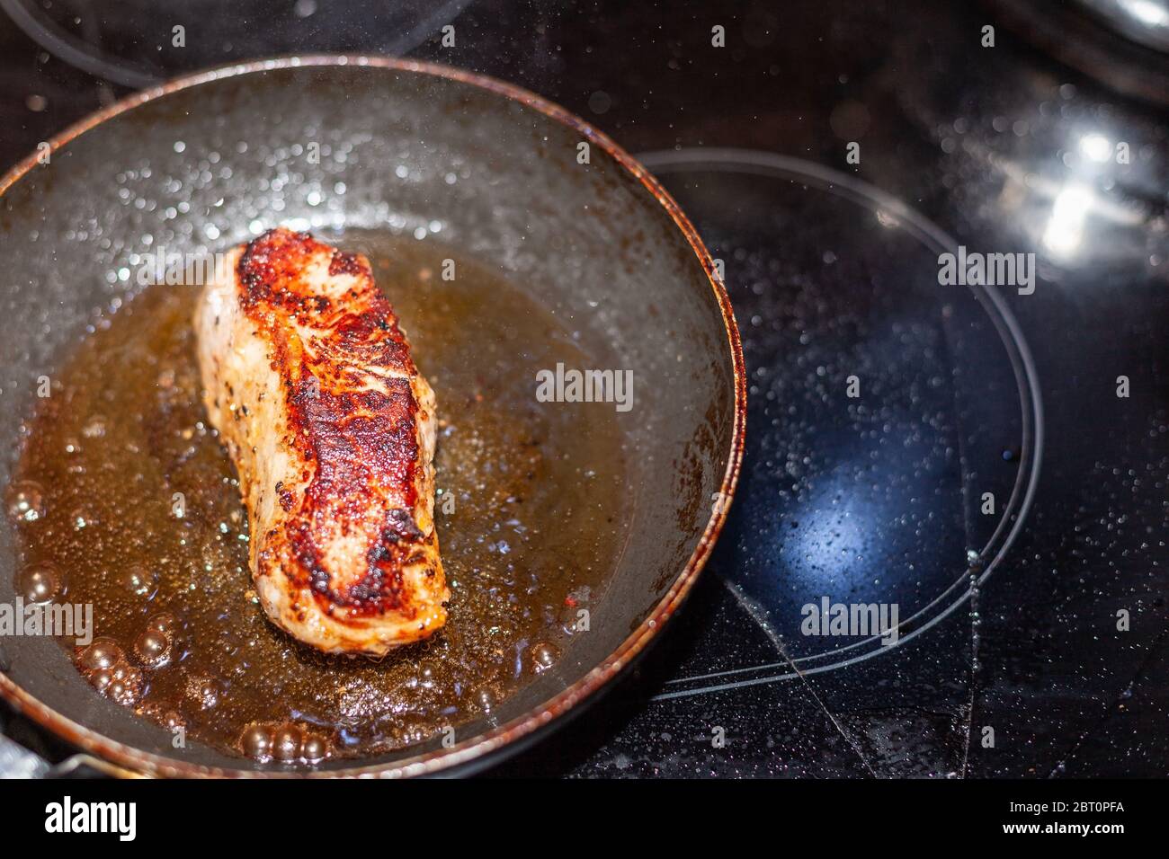 Finished veal steak in a pan while roasting Stock Photo Alamy
