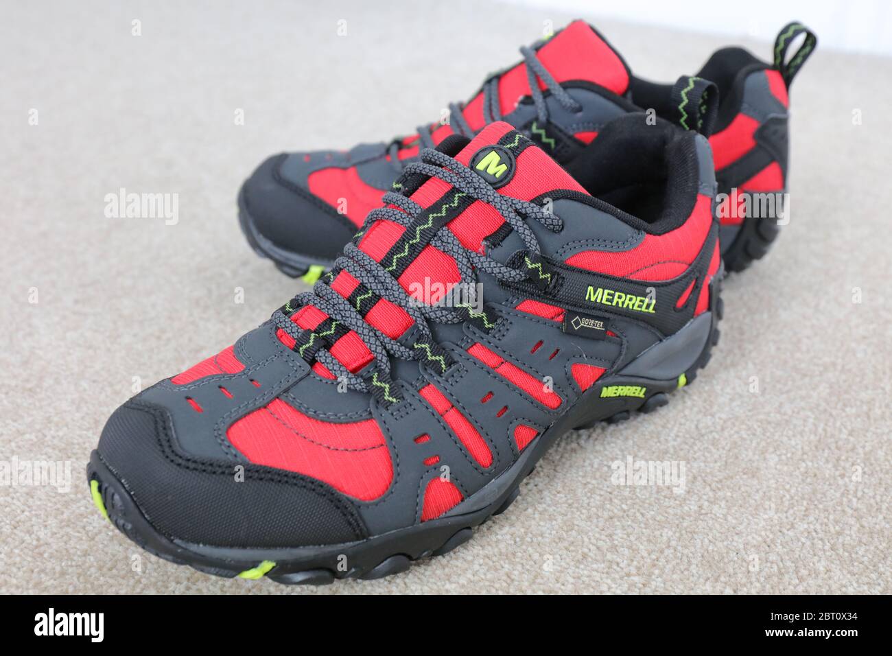 A Pair of a Merrell Red Accentor Sport GORE-TEX Trail Shoes Stock Photo -  Alamy