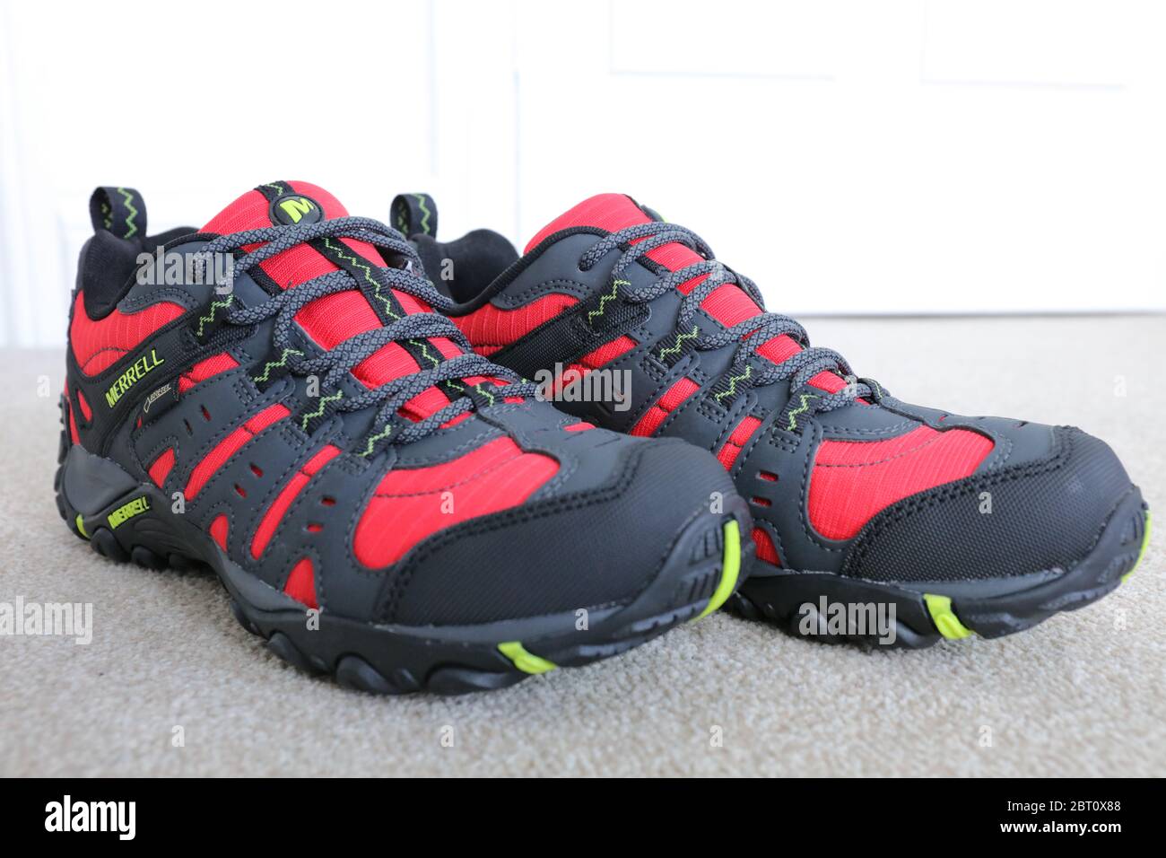 A Pair of a Merrell Red Accentor Sport GORE-TEX Trail Shoes Stock Photo -  Alamy