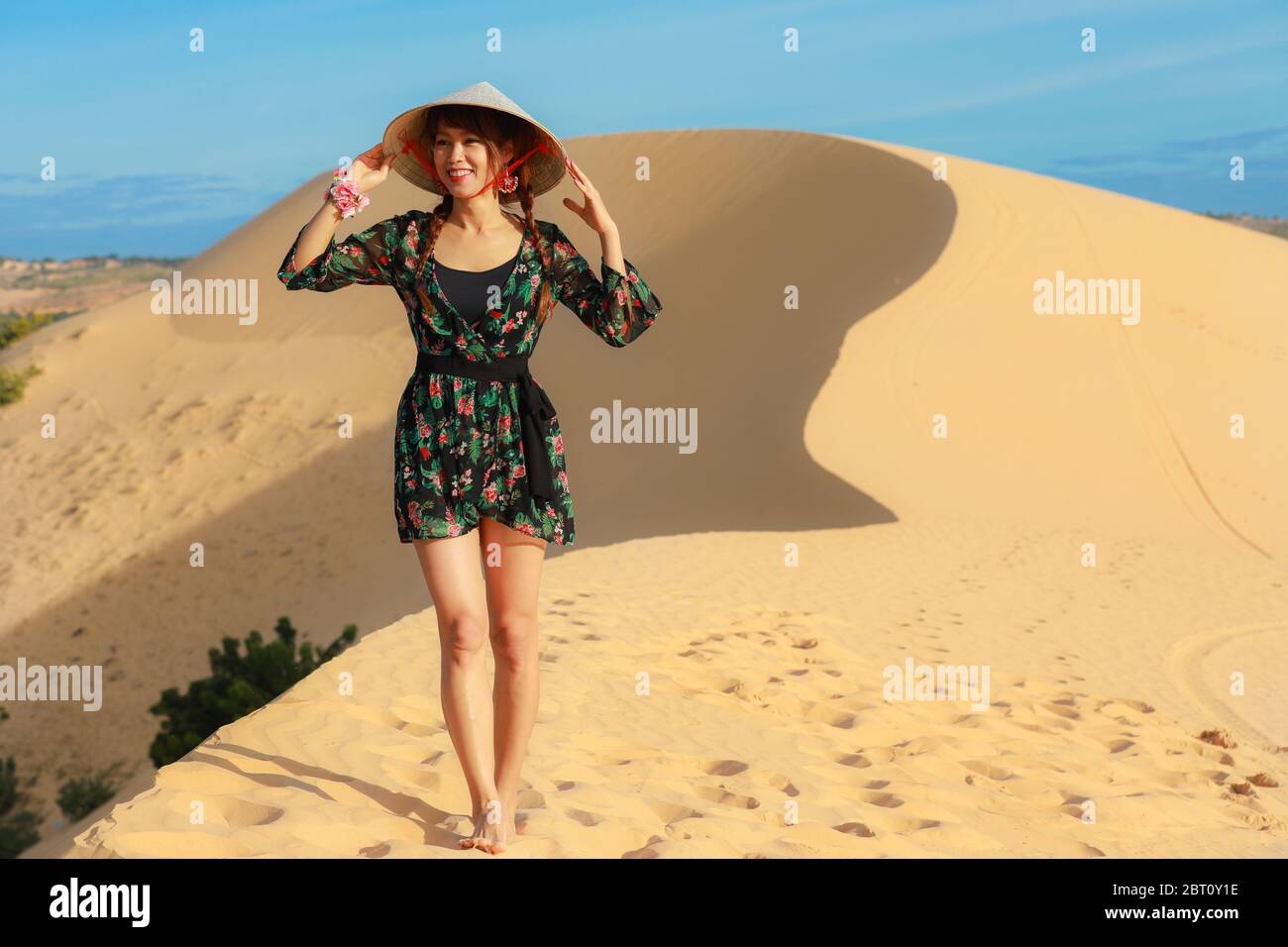 Beautiful asian woman enjoy her vacation on white sand dune in Mui ne, Vietnam Stock Photo