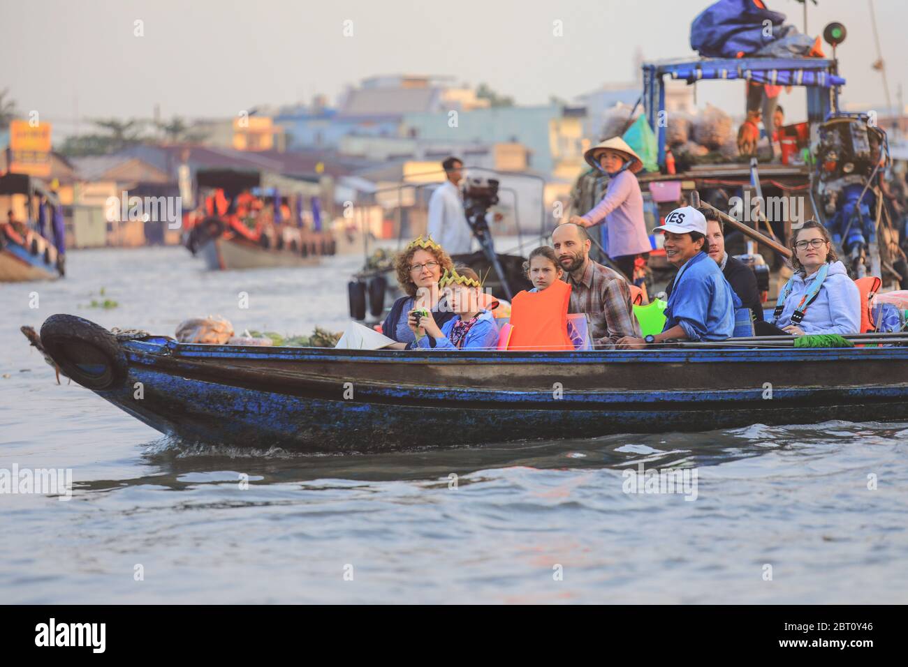 Mekong Delta - Vietnam - January 24, 2019 : Happy family ride on traditional Vietnamese boat at Mekong delta, popular travel destination for day tour Stock Photo