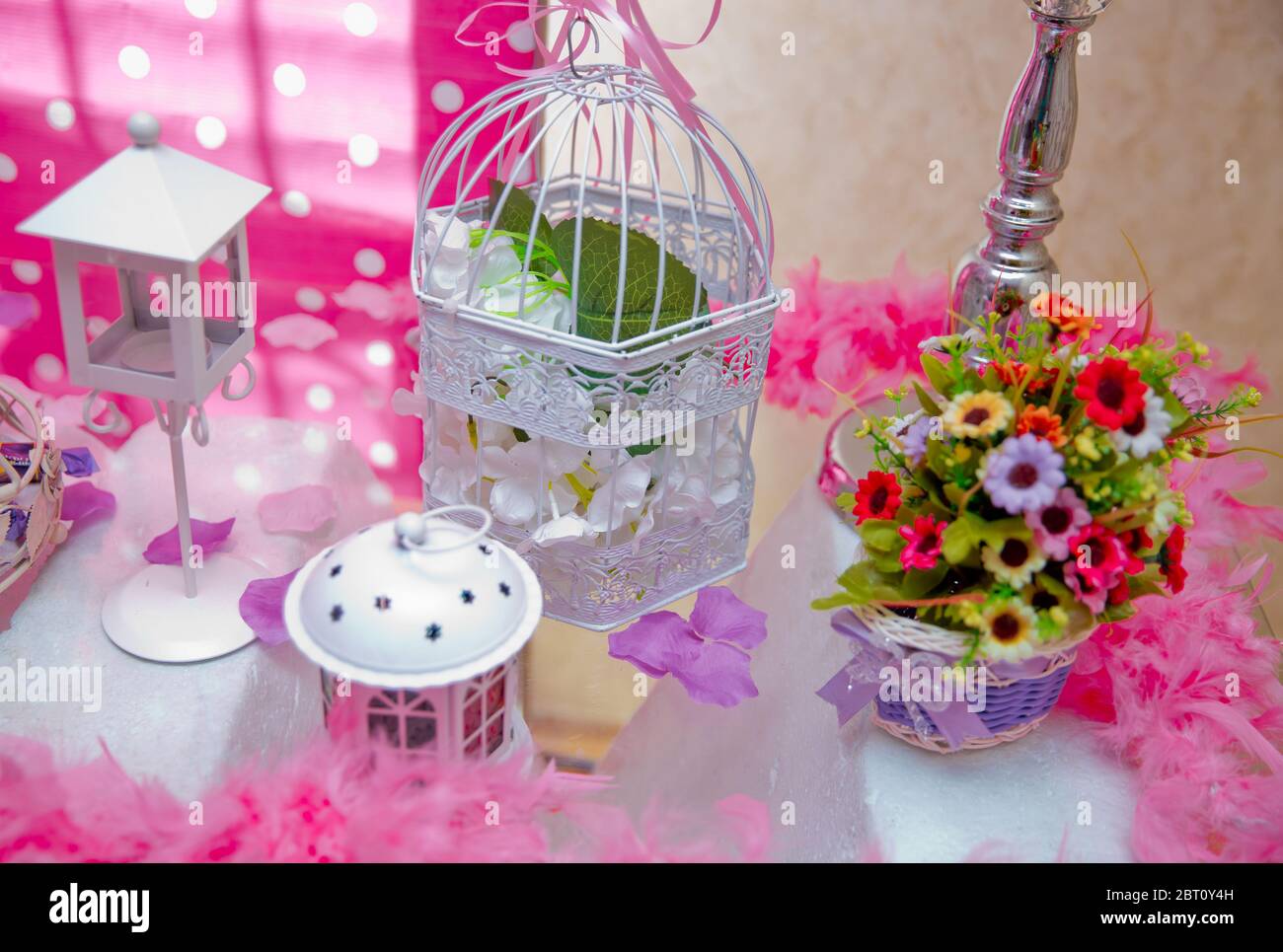flower arrangements . The cage with flowers stand in restaurant . white