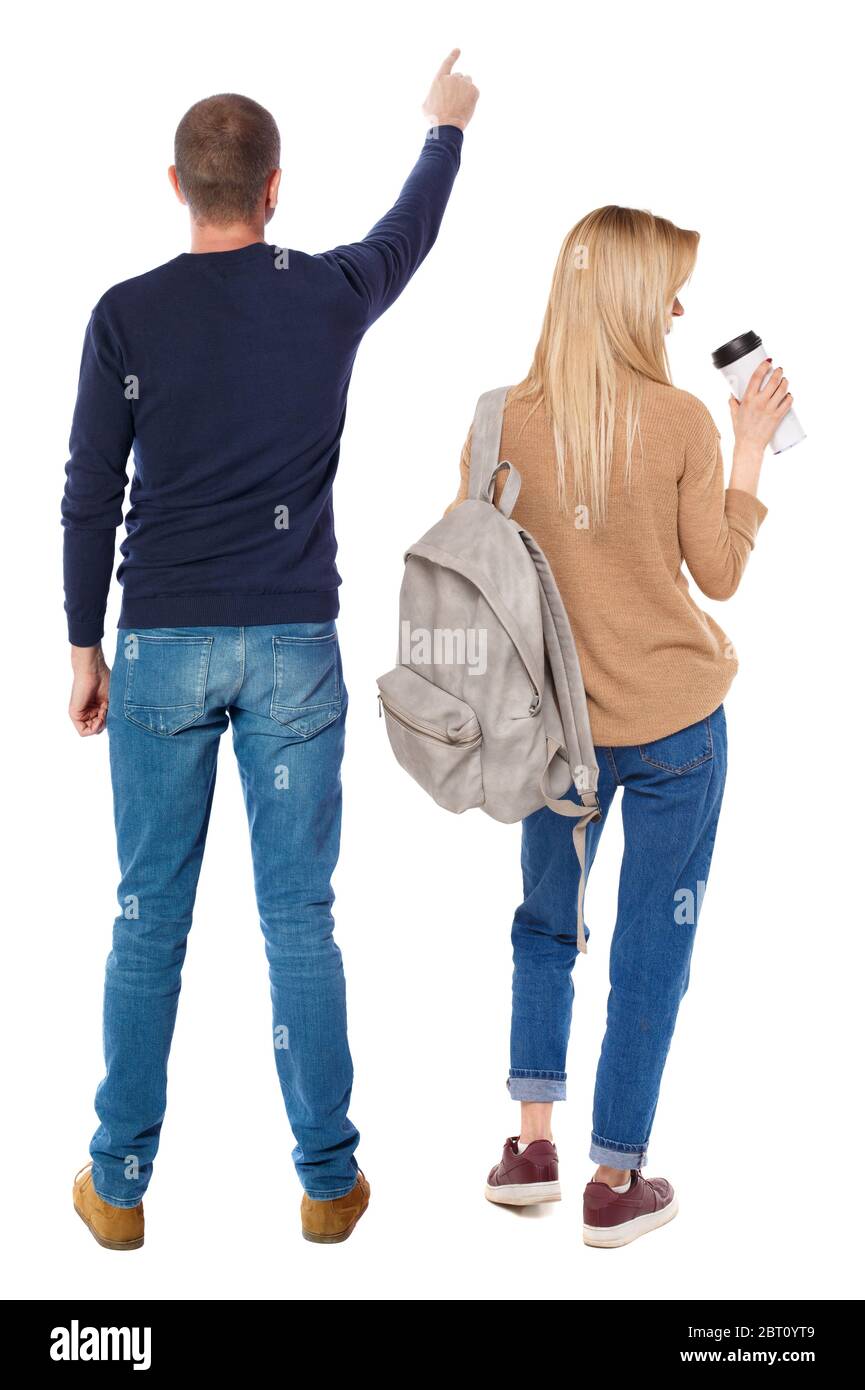 Back view of couple in sweater pointing. Rear view people collection ...