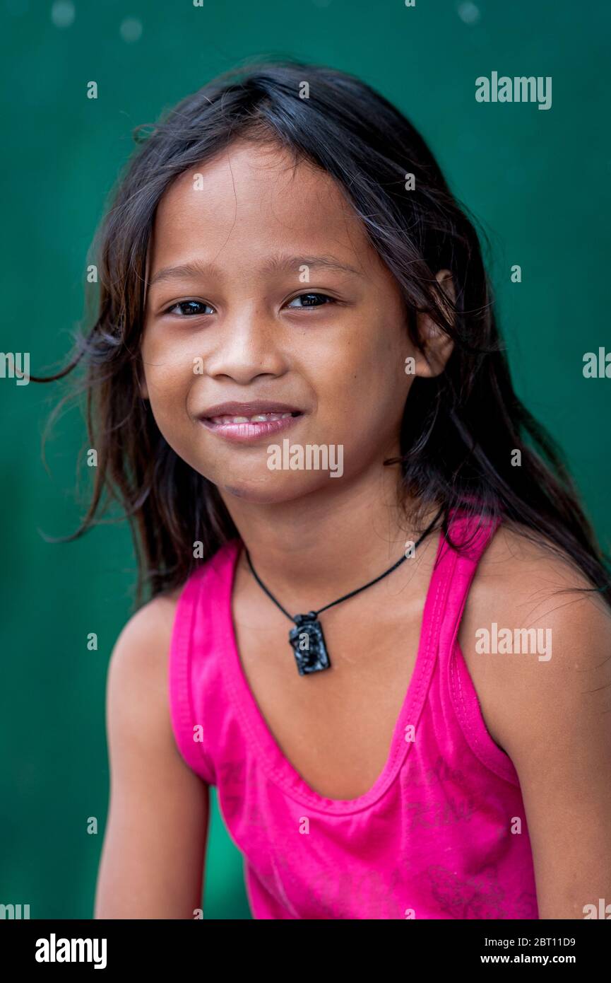 A pretty young Filipino girl poses and smiles for my camera in the old walled city of Intramuros, Manila, The Philippines. Stock Photo