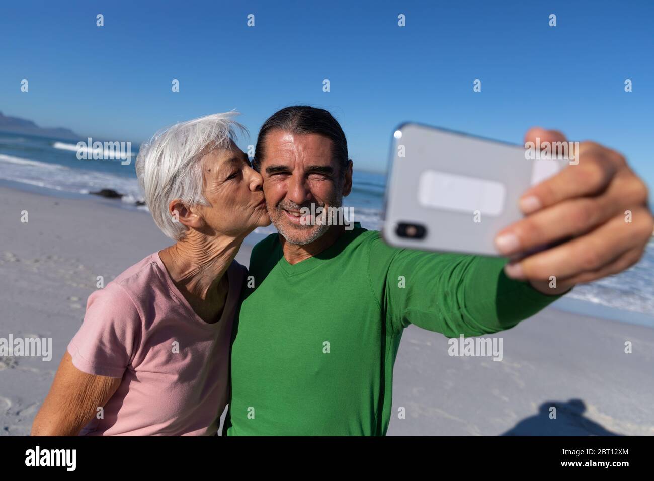 Senior Caucasian couple taking a selfie at the beach. Stock Photo