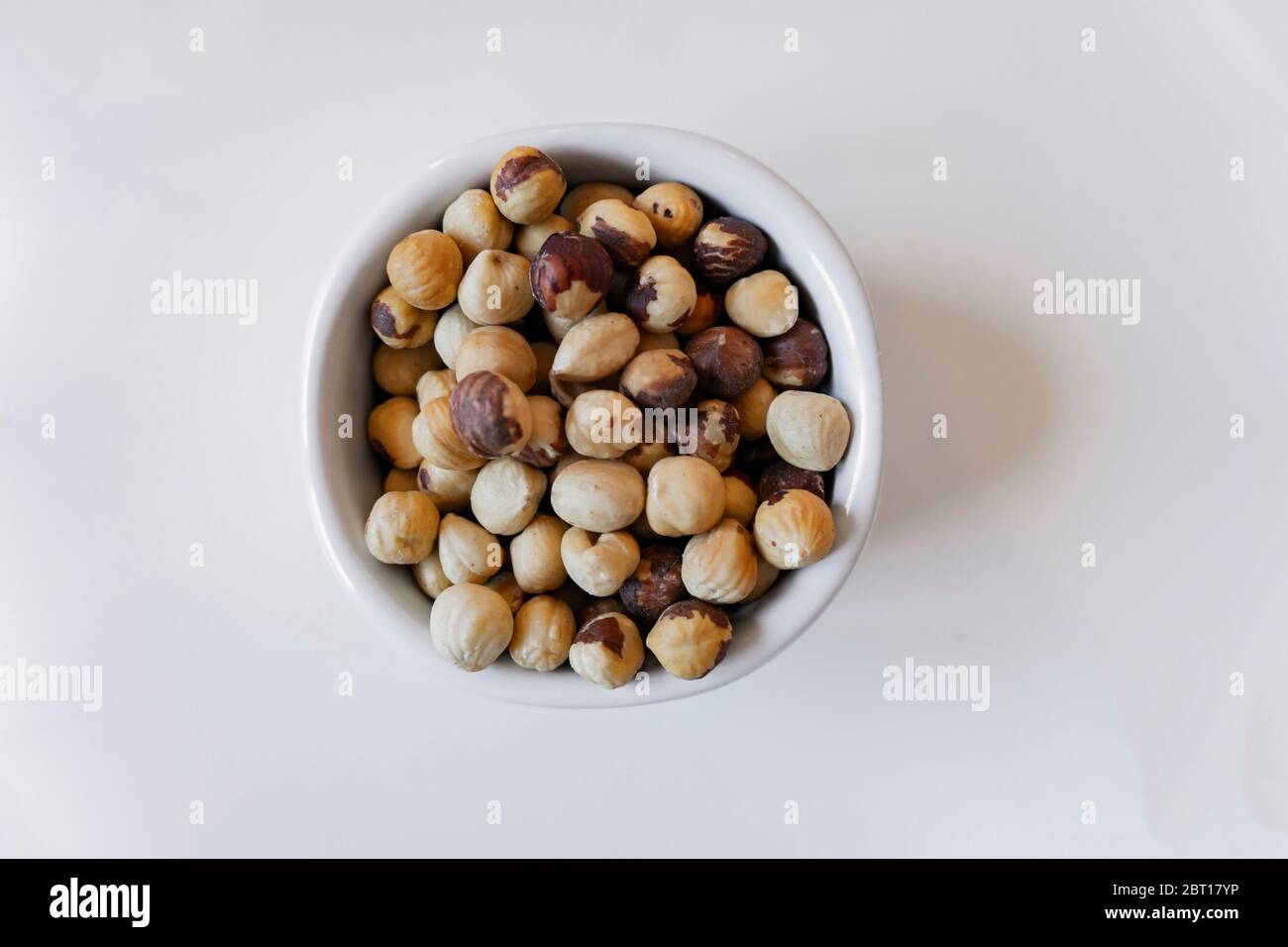 hazelnuts isolated in a white pot Stock Photo