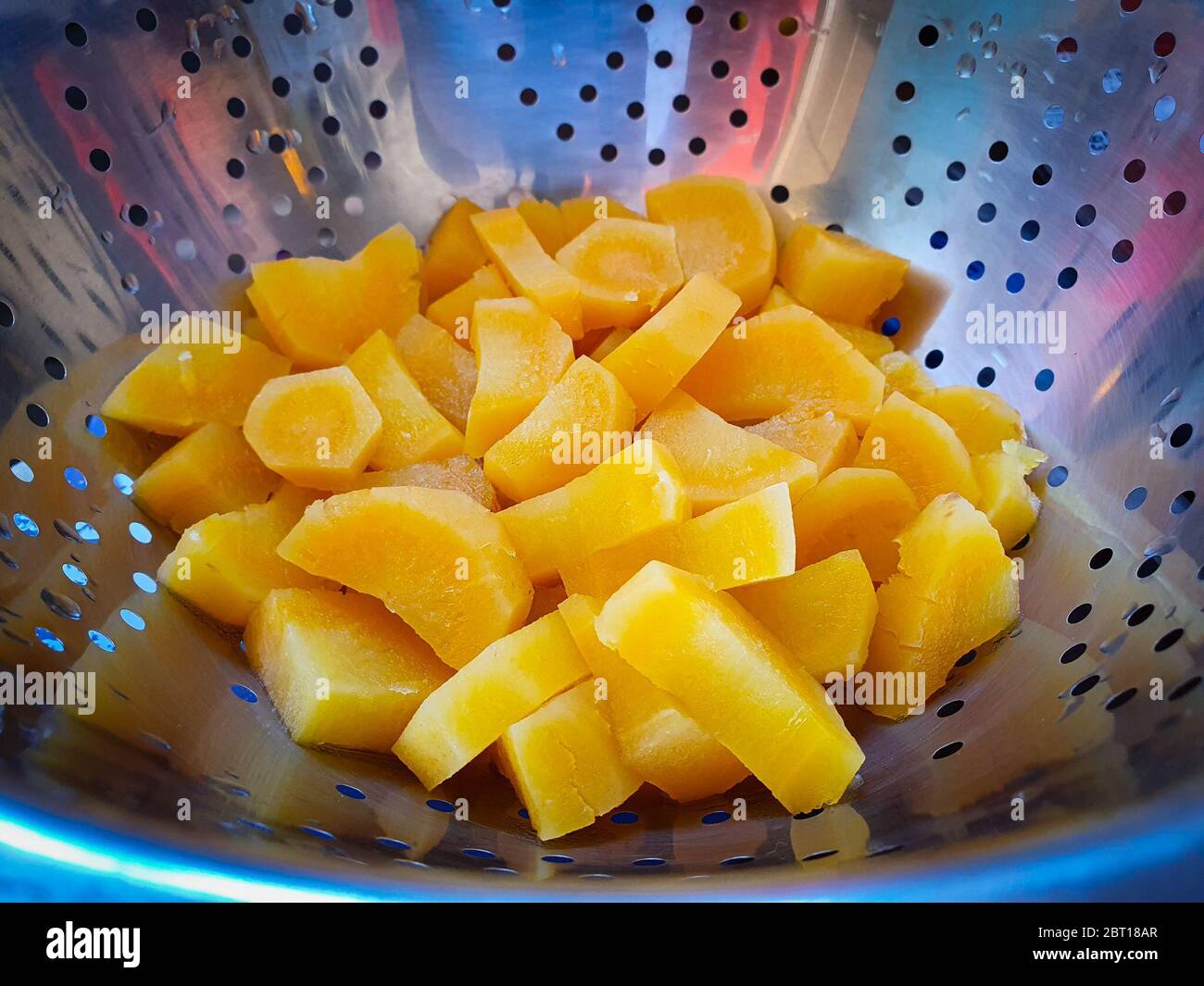 Close-up of chopped parsnips in a colander Stock Photo