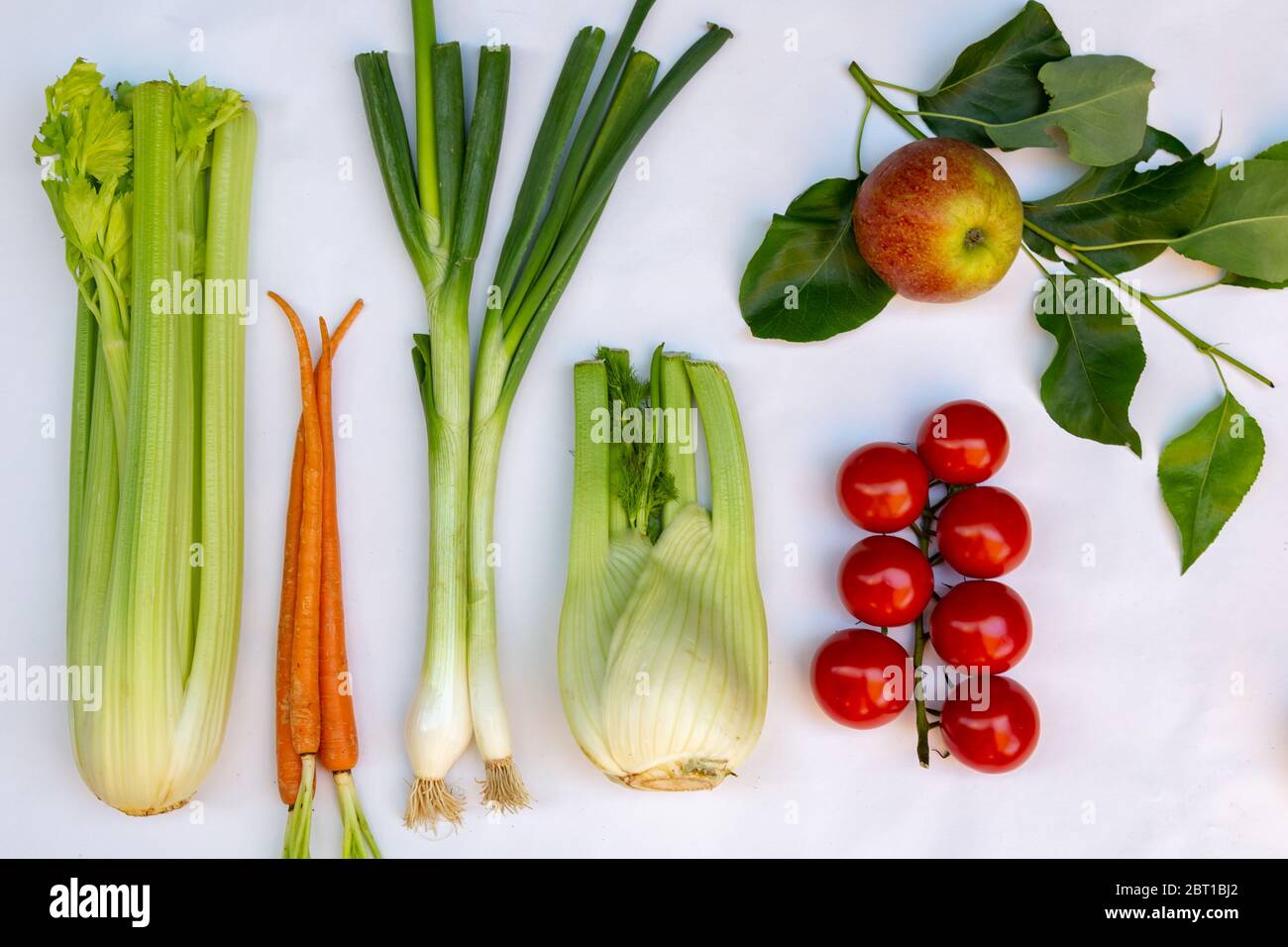 Flat lay with different kinds of fresh local vegetables en fruits like, celery, spring onion, tomato, apple, zucchini, chicory and fennel Stock Photo