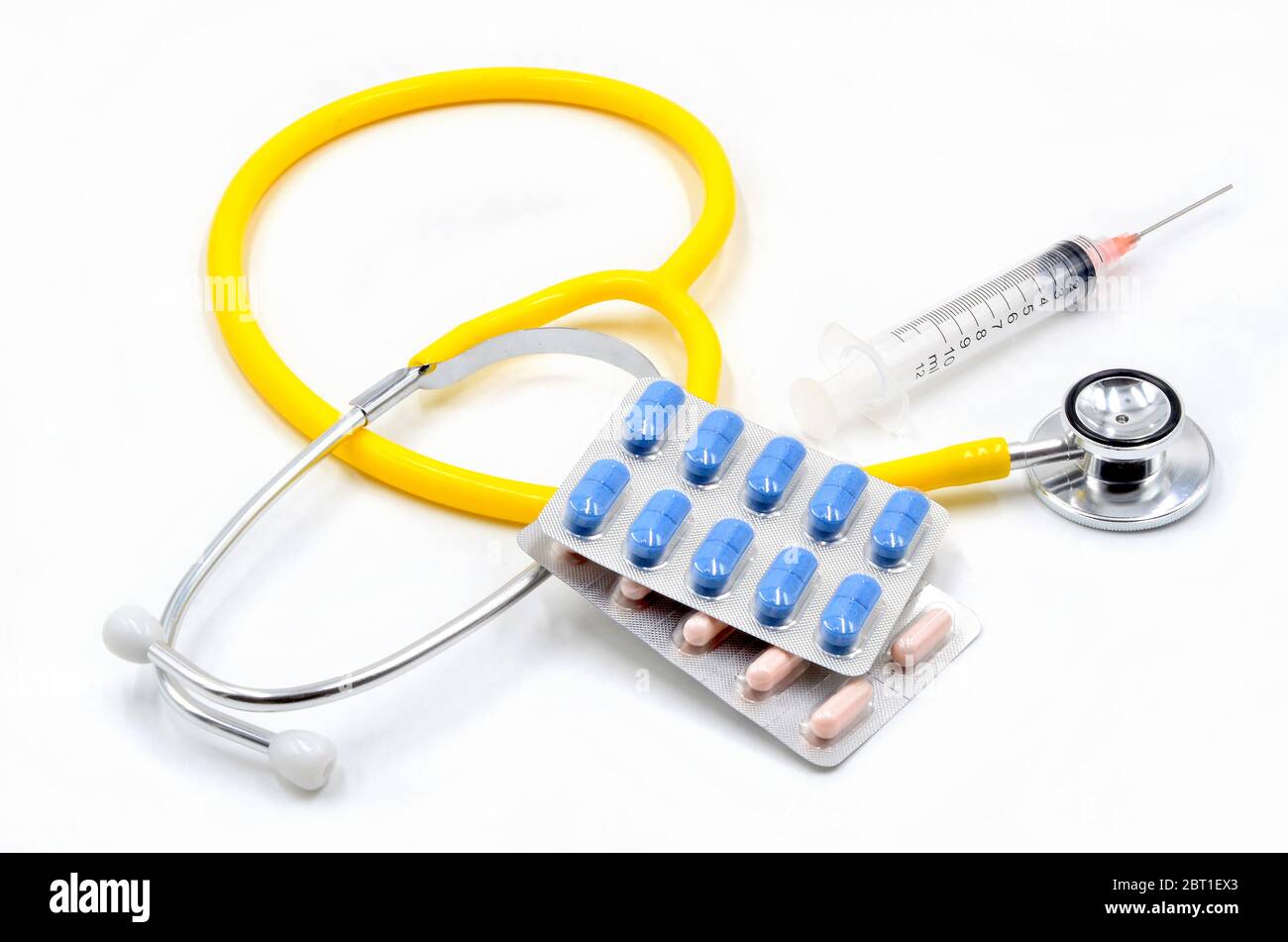 Stethoscope with syringe and pills on white background Stock Photo - Alamy