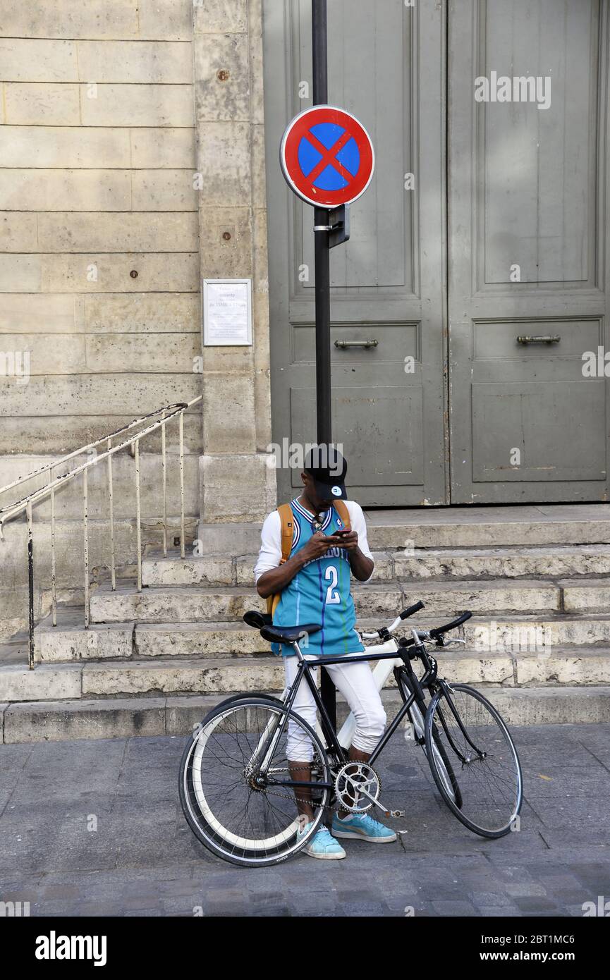 Young man with bicycle - Paris - France Stock Photo