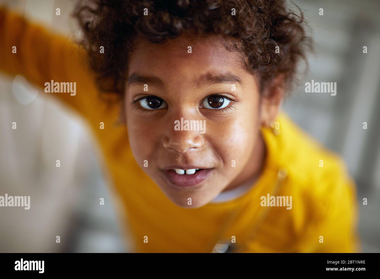 portrait of cute afro-american girl. Afro american cute little girl with curly hair. Stock Photo