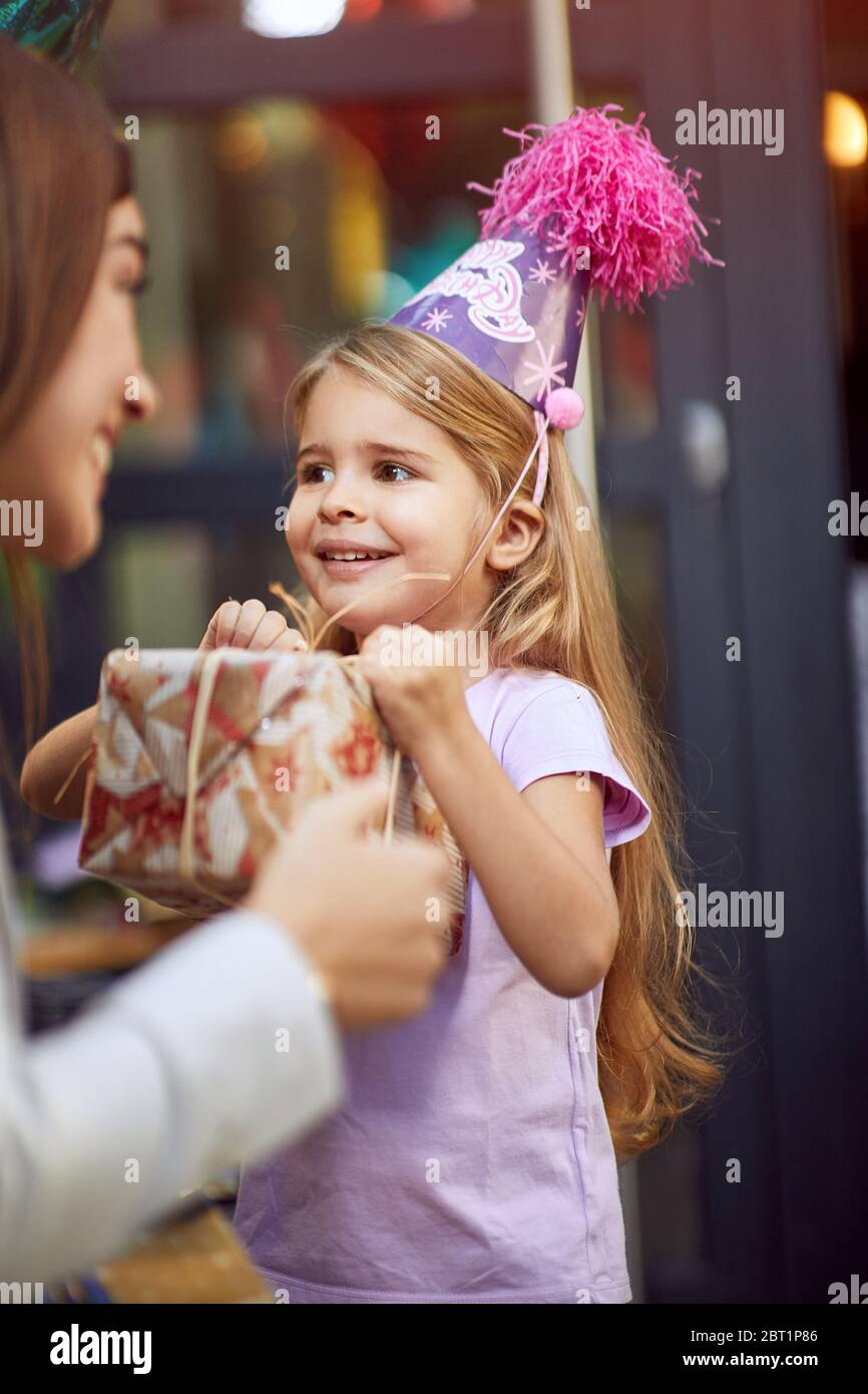 Birthday party at home. Mother celebrate happy child girl birthday and