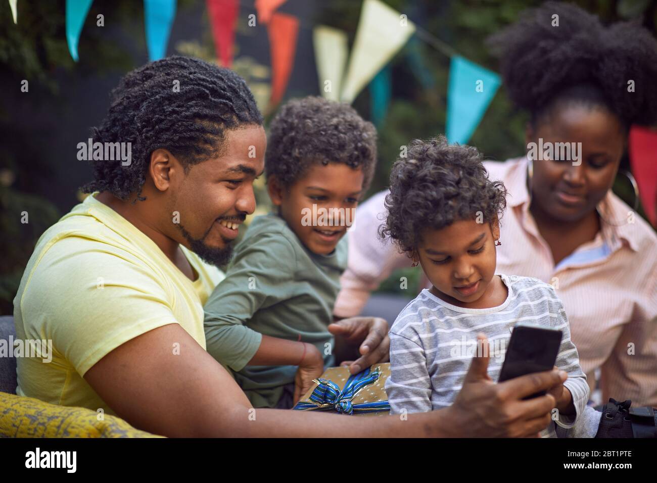 young afro-american family  at birthday party have fun and making selfie. Stock Photo