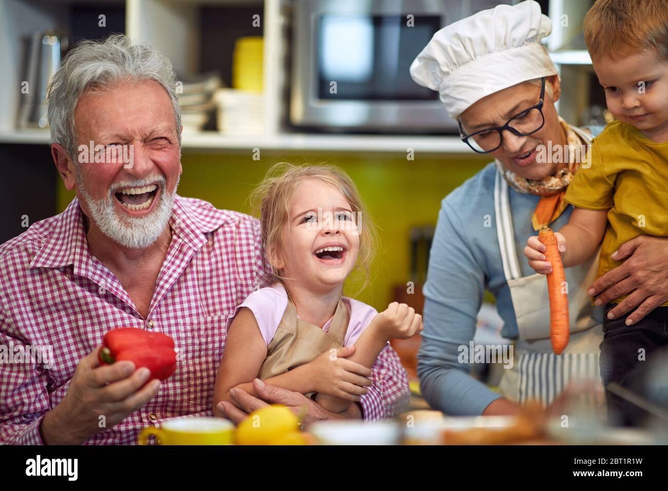 Happy grandparents with young grandchildren making breakfast in kitchen Stock Photo - Alamy Happy grandparents with young grandchildren making breakfast in kitchen Stock Photo - Alamy