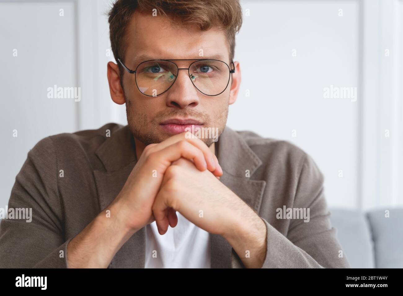 Handsome young man resting chin on his hands Stock Photo - Alamy