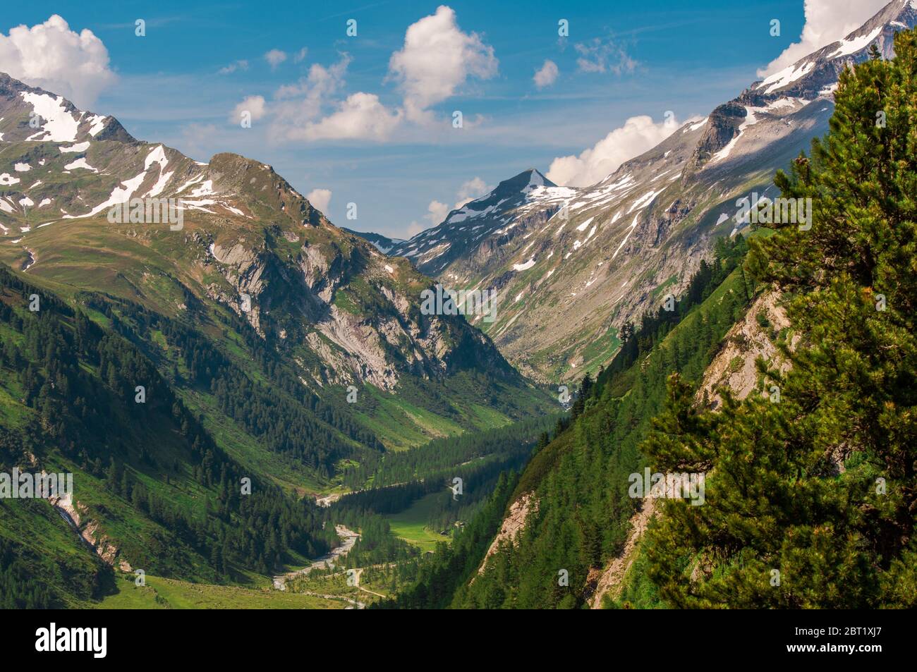 Aerial View Of Austrian Alps With Dirt Road In Valley And Mountain ...